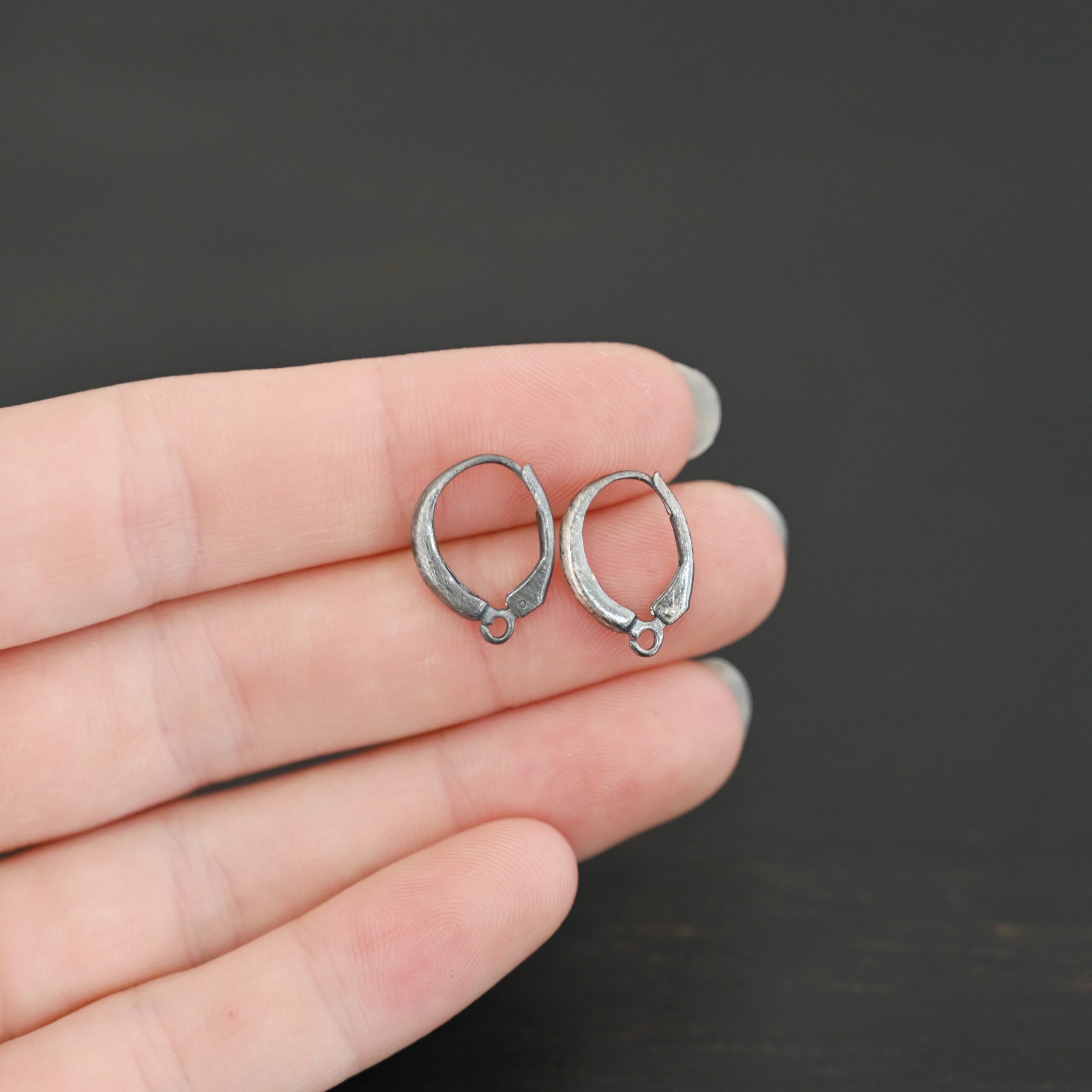 sterling silver Willa lever back ear wires - oxidized shown in hand