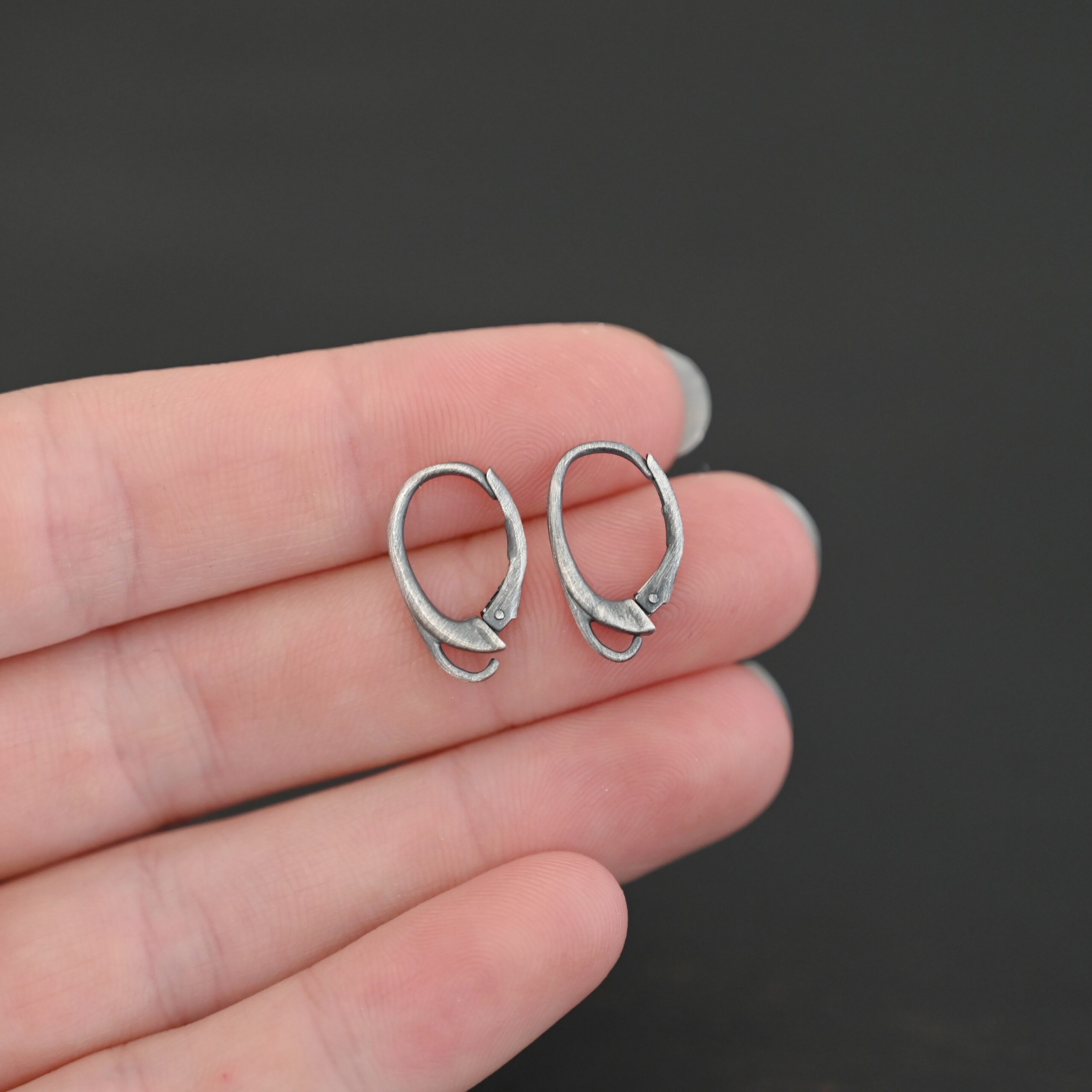 sterling silver Wendy lever back ear wires - oxidized shown in hand