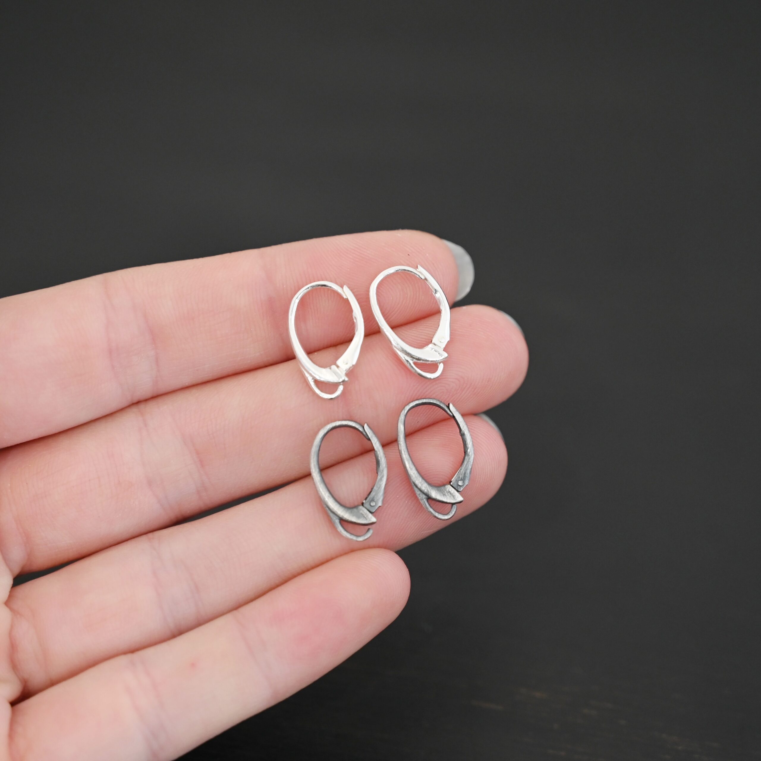 sterling silver Wendy lever back ear wires - oxidized & shiny shown in hand
