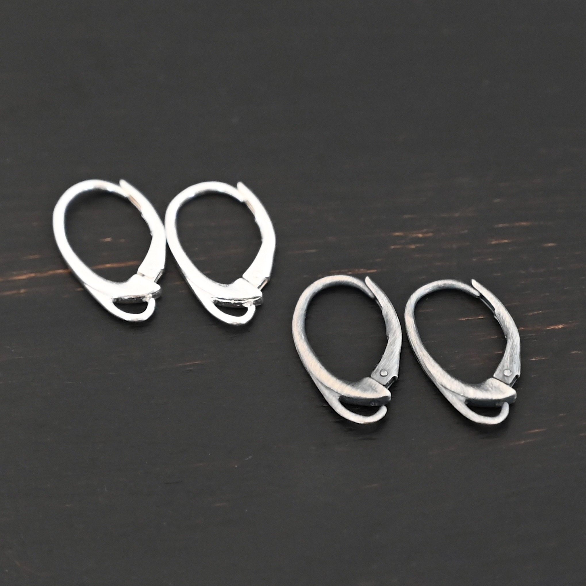 sterling silver Wendy lever back ear wires - oxidized & shiny on dark background