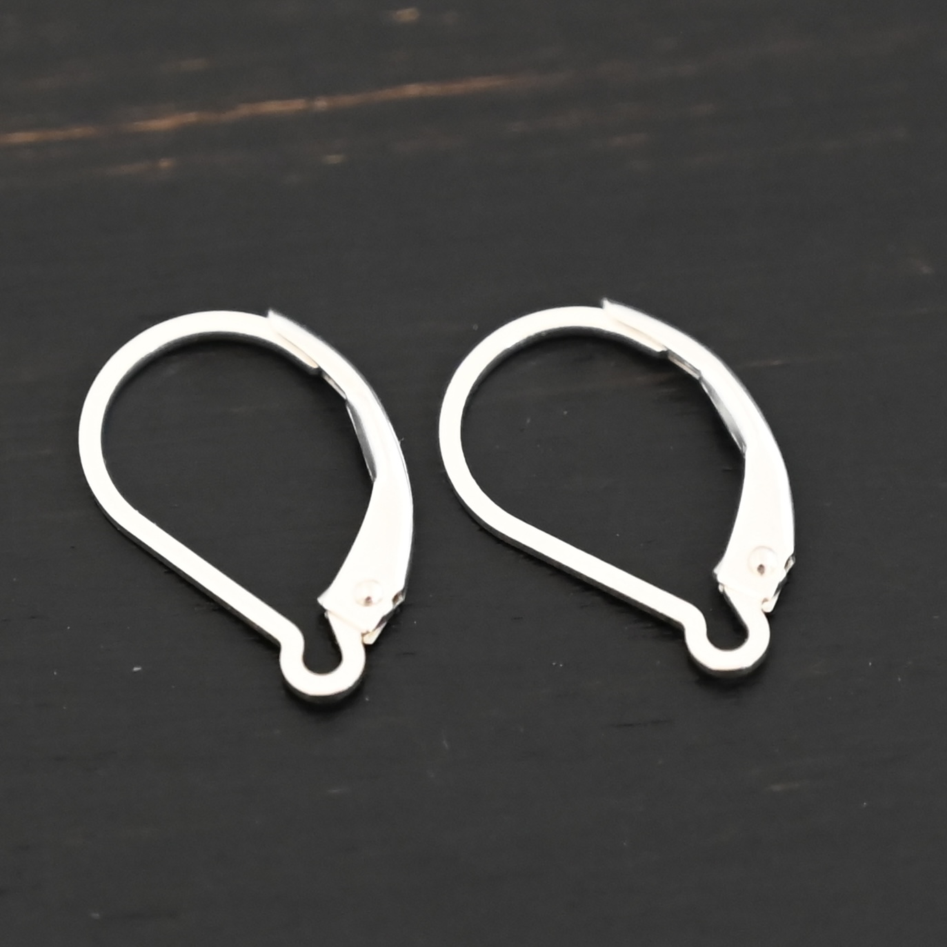sterling silver Waverly lever back ear wires - shiny on dark background