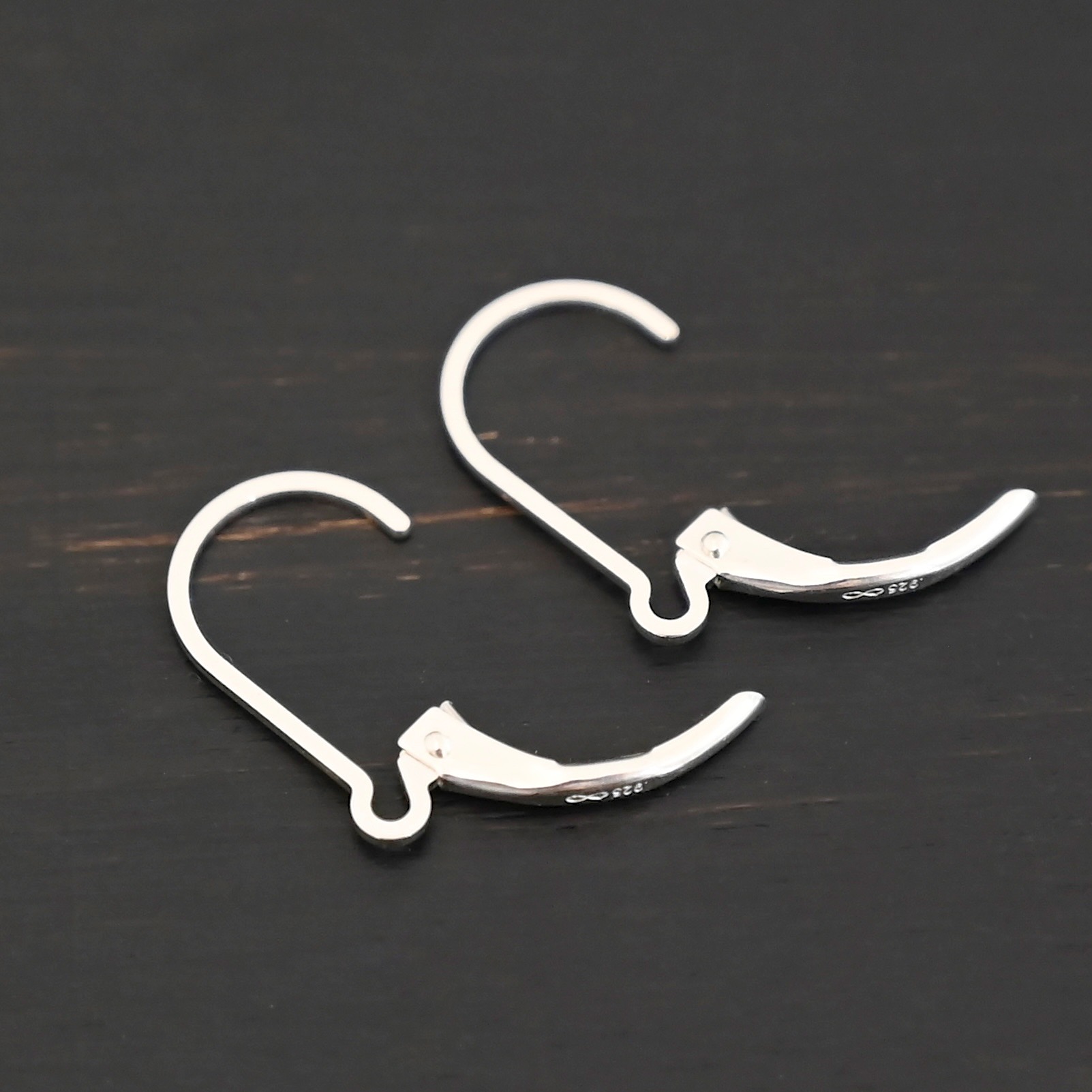 sterling silver Waverly lever back ear wires - shiny on dark background
