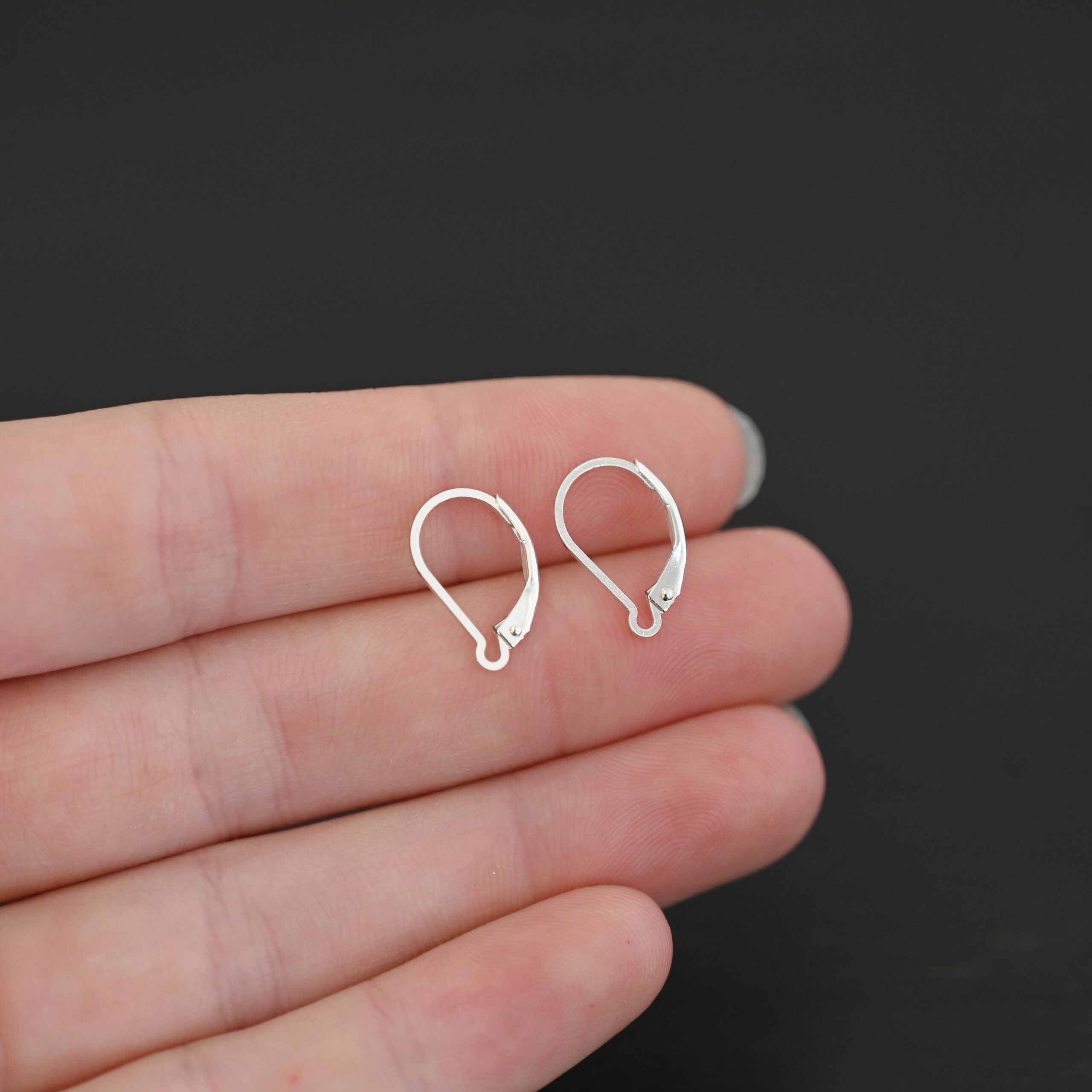 sterling silver Waverly lever back ear wires - shiny shown in hand