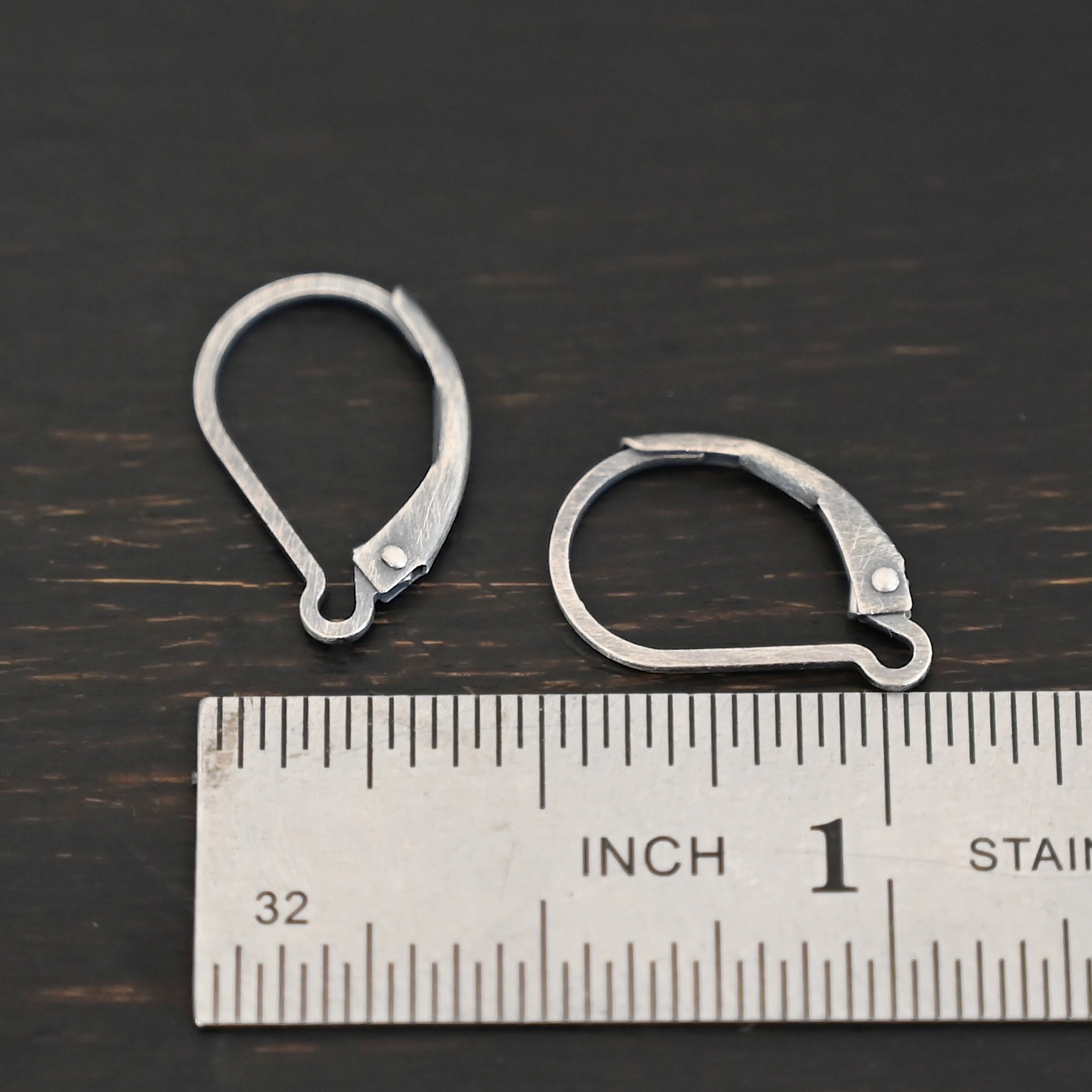 sterling silver Waverly lever back ear wires - oxidized shown by ruler