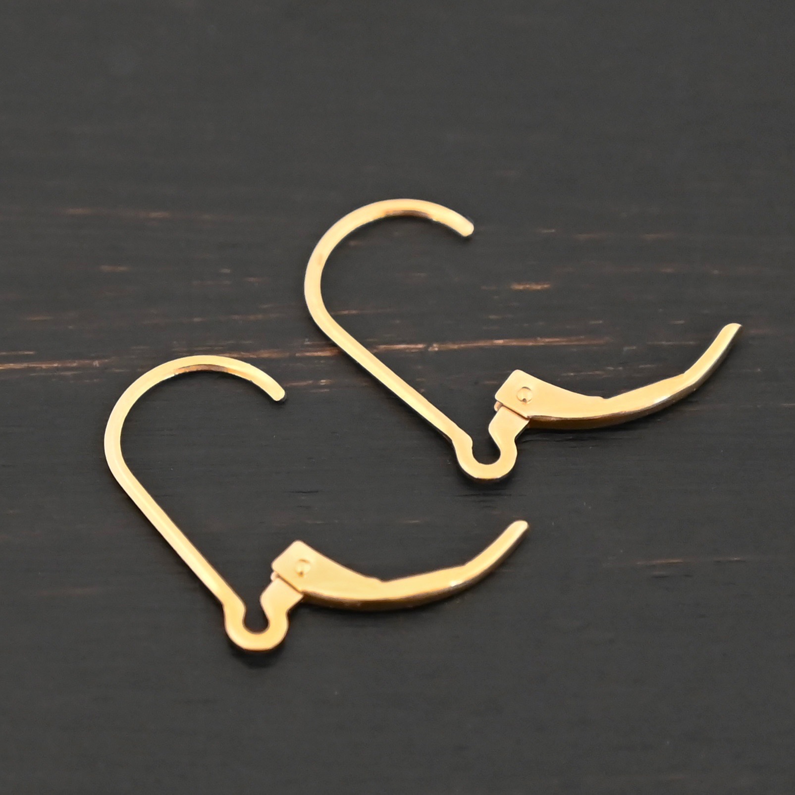 14k gold filled Waverly lever back ear wires shown on dark background