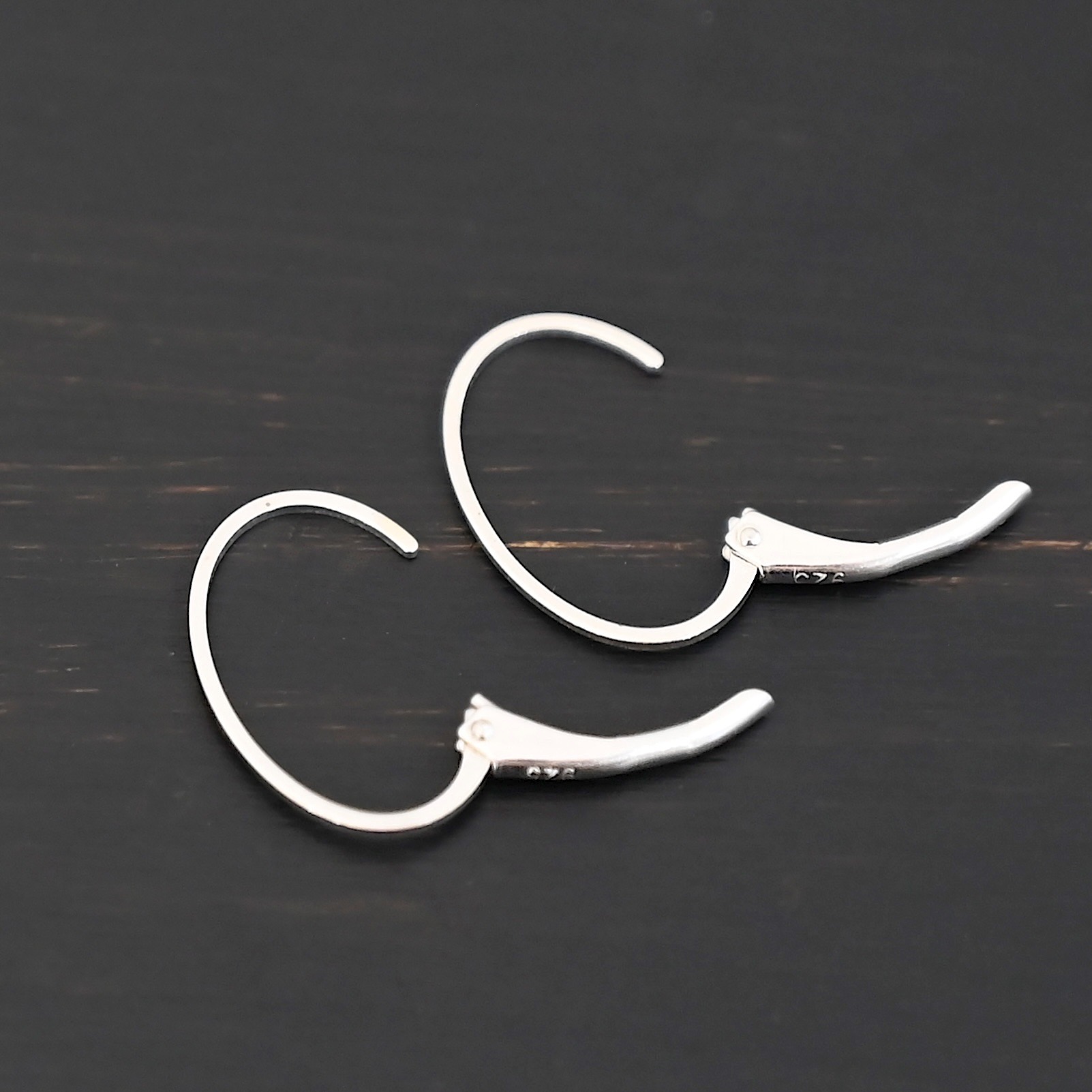 Wren leverback ear wires - shiny Sterling silver Wren lever back ear wires - shiny, shown on dark background