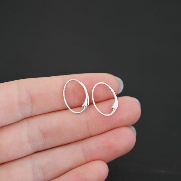 Sterling silver Wren lever back ear wires - shiny, shown in hand