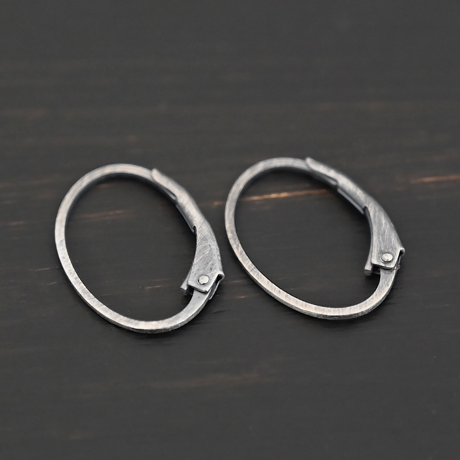 Wren leverback ear wires - oxidized Sterling silver Wren lever back ear wires - oxidized, shown on dark background