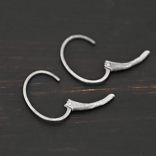 Sterling silver Wren lever back ear wires - oxidized, shown on dark background