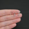 Sterling silver Wren lever back ear wires - oxidized, shown in hand