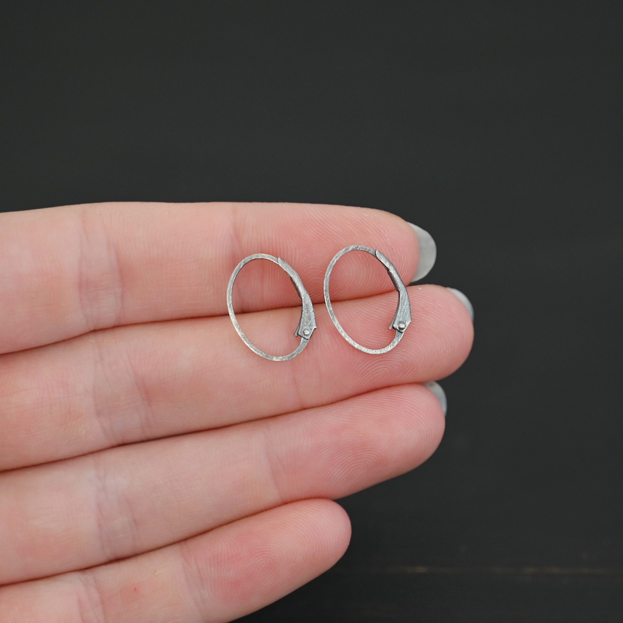 Wren leverback ear wires - oxidized Sterling silver Wren lever back ear wires - oxidized, shown in hand