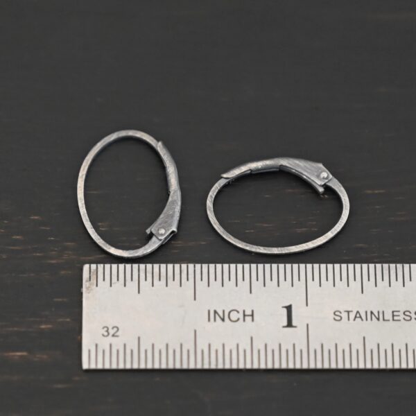 Sterling silver Wren lever back ear wires - oxidized, shown by ruler