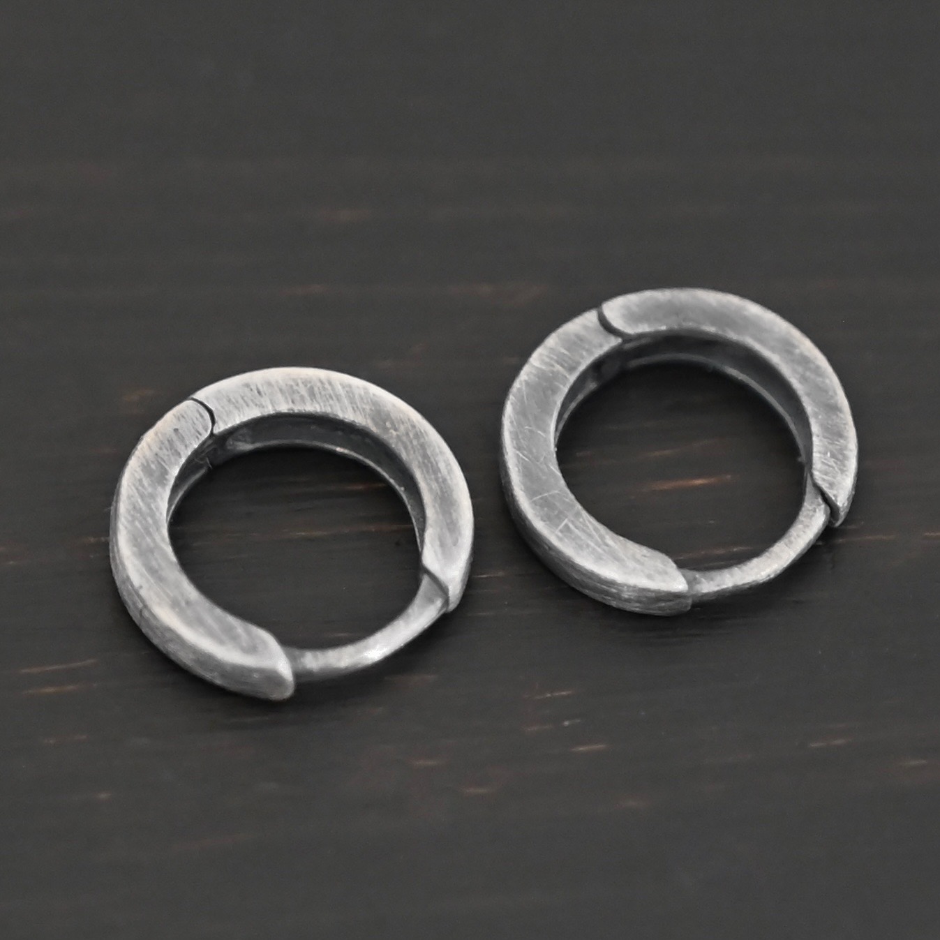 Winona Huggie Hoop Earrings - oxidized sterling silver Winona Huggie Hoop Earrings - oxidized shown on dark background