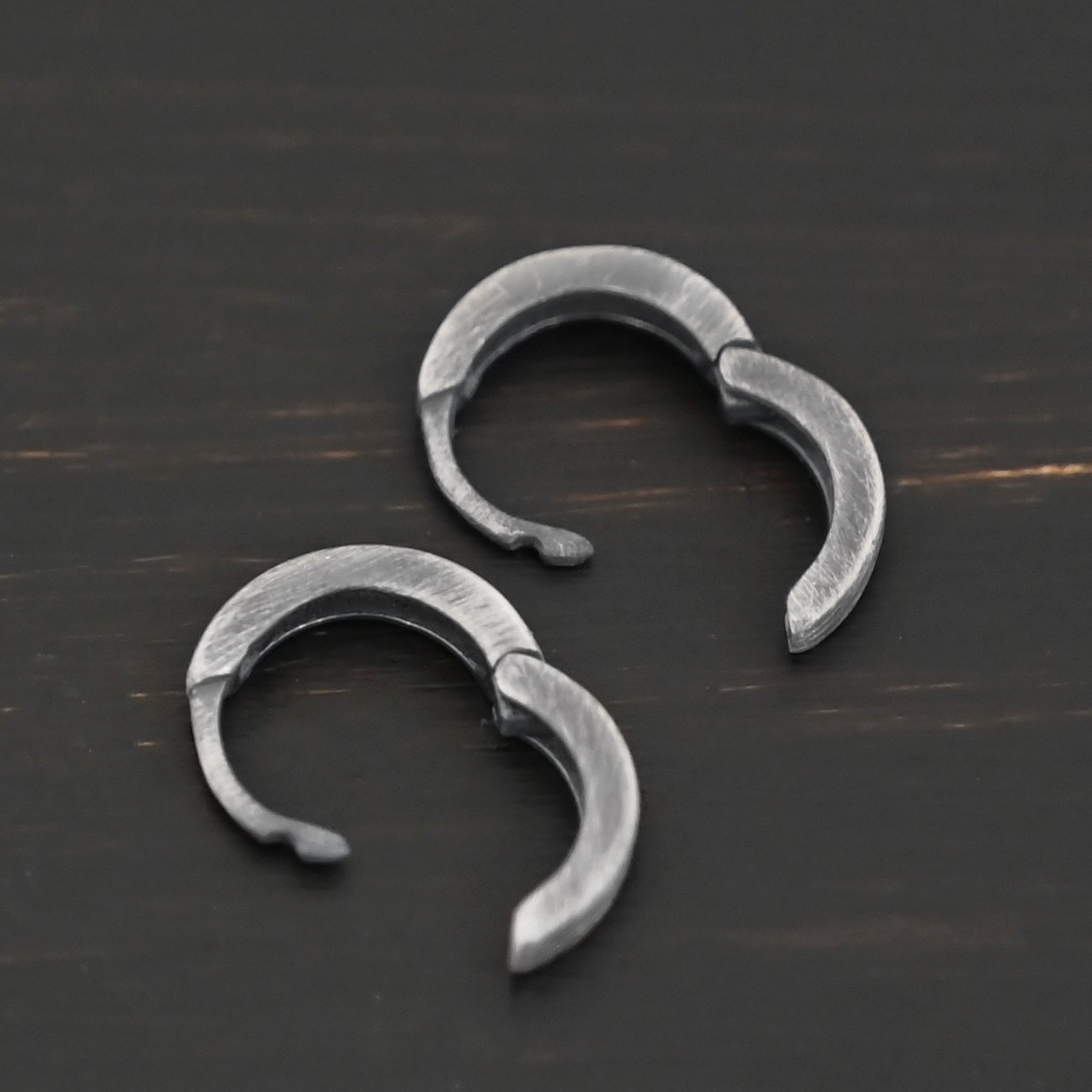 Winona Huggie Hoop Earrings - oxidized sterling silver Winona Huggie Hoop Earrings - oxidized shown on dark background