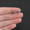 sterling silver Winona Huggie Hoop Earrings - oxidized shown in hand