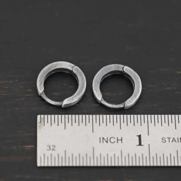 sterling silver Winona Huggie Hoop Earrings - oxidized shown by ruler