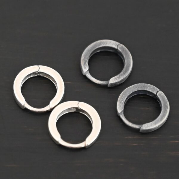 sterling silver Winona Huggie Hoop Earrings - oxidized & shiny shown on dark background