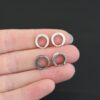 sterling silver Winona Huggie Hoop Earrings - oxidized & shiny shown in had