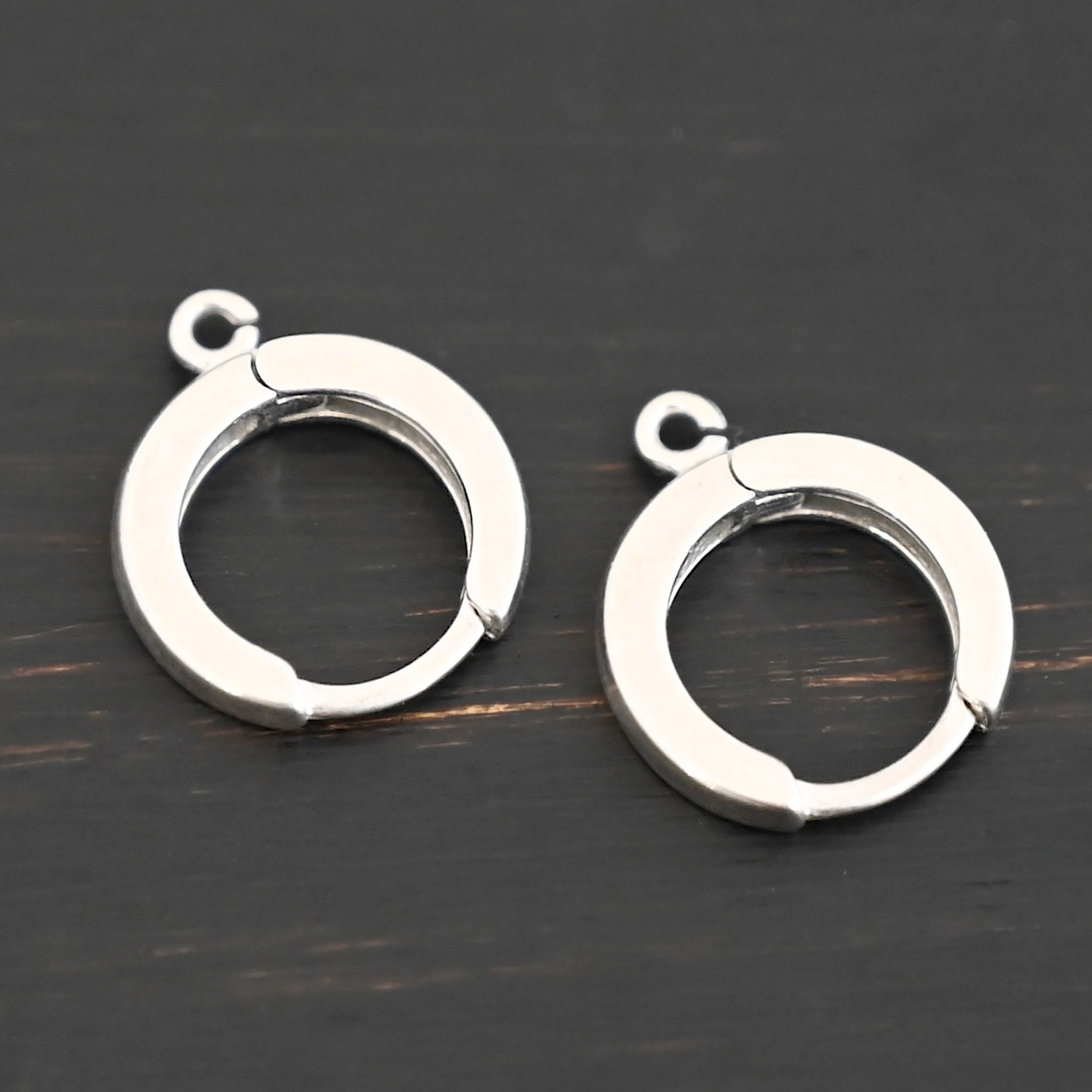 Sterling sIlver Winifred Huggie Hoops - shiny shown on dark background