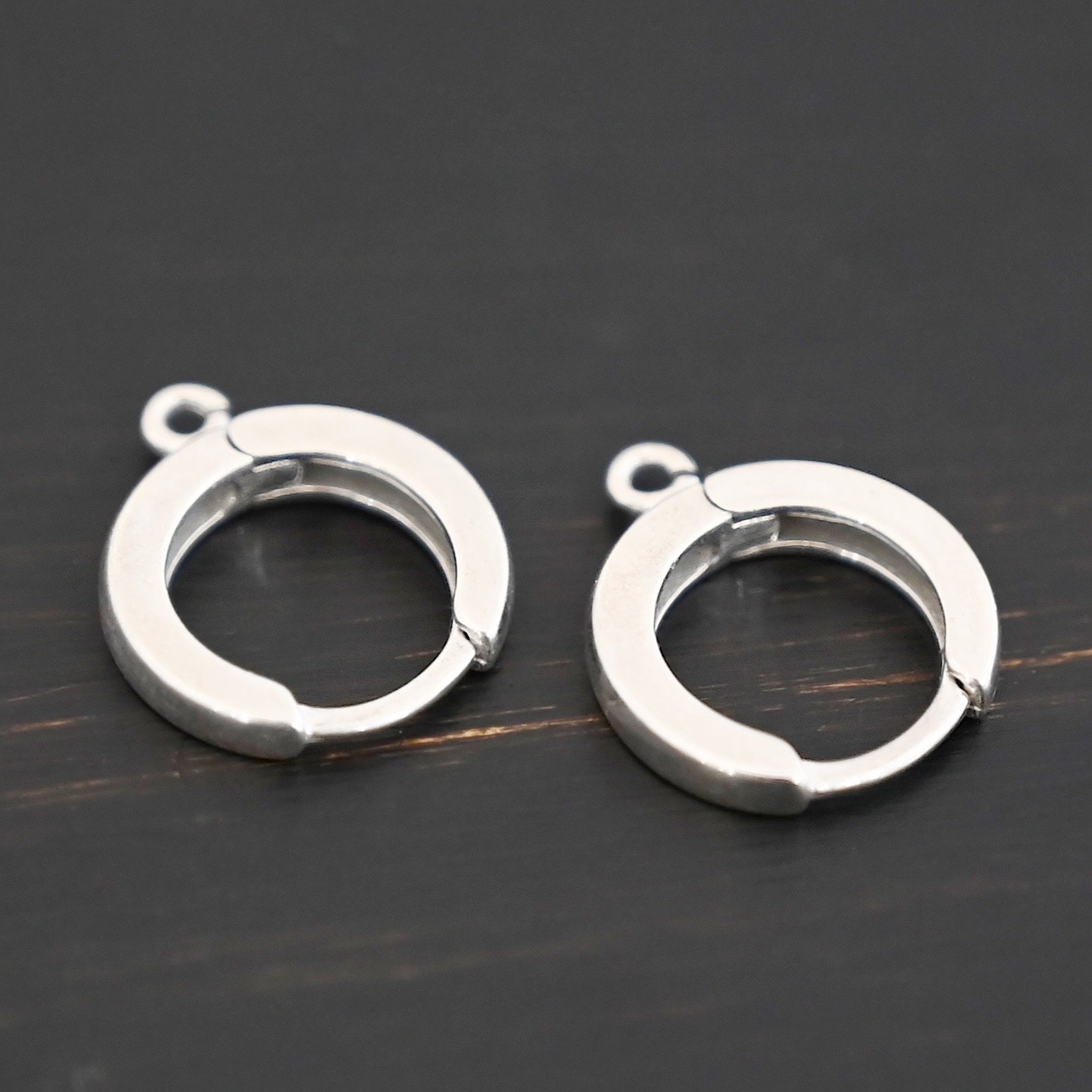 Sterling sIlver Winifred Huggie Hoops - shiny shown on dark background