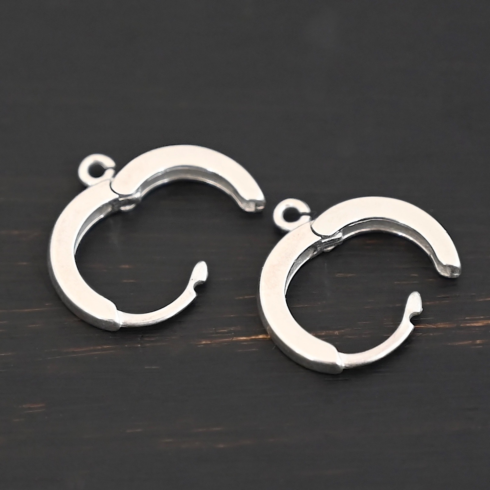 Sterling sIlver Winifred Huggie Hoops - shiny shown on dark background