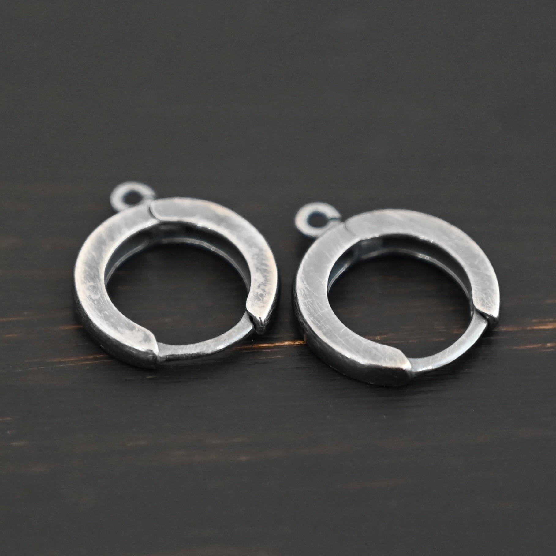 Sterling sIlver Winifred Huggie Hoops - oxidized shown on dark background