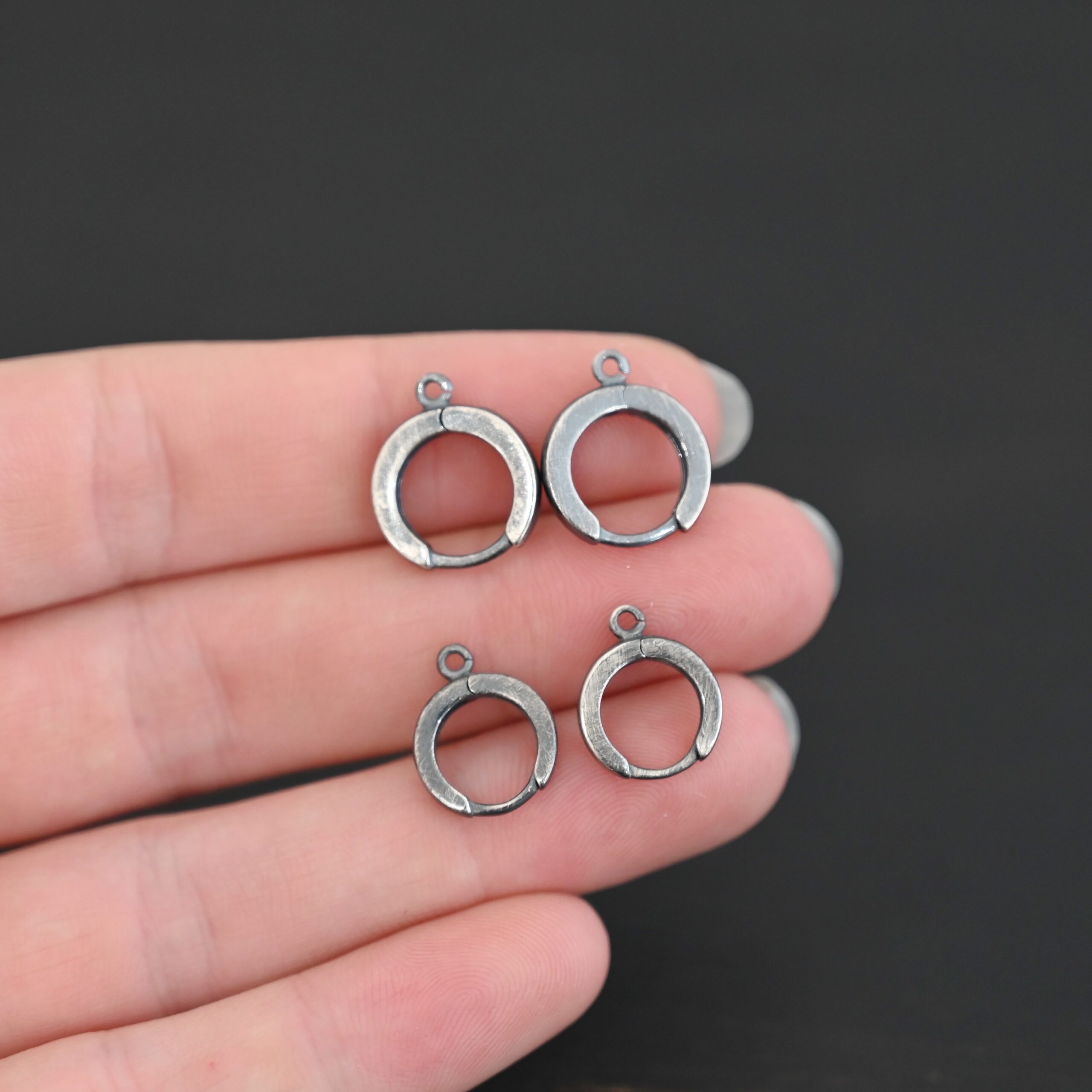 Sterling sIlver Winifred Huggie Hoops - oxidized shown in hand