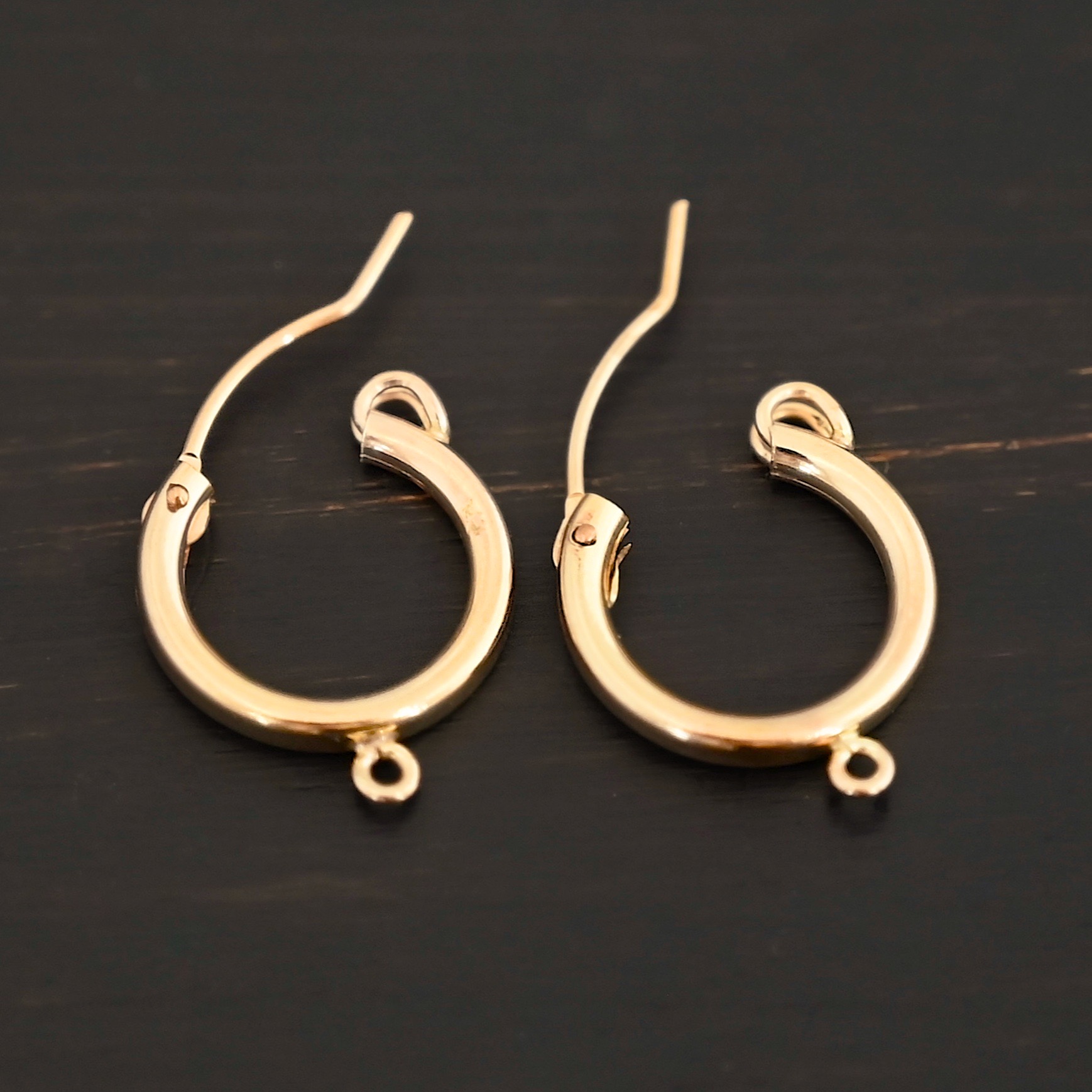 West 14k gold filled hoops shown on dark background