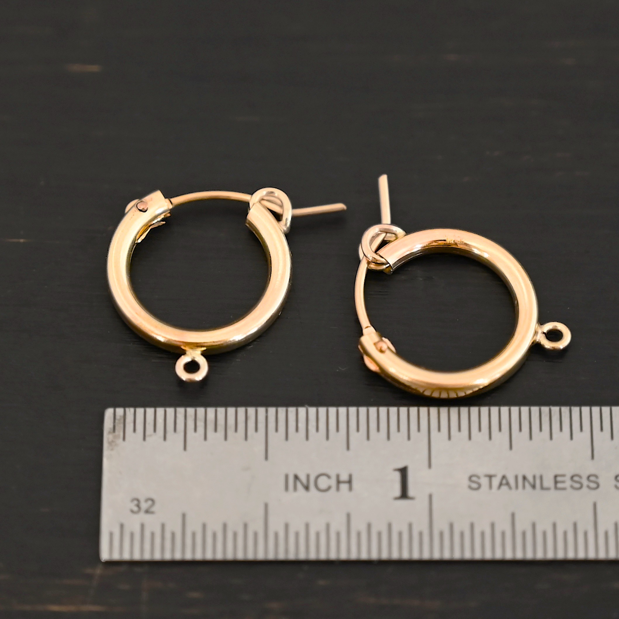 West 14k gold filled hoops shown by ruler