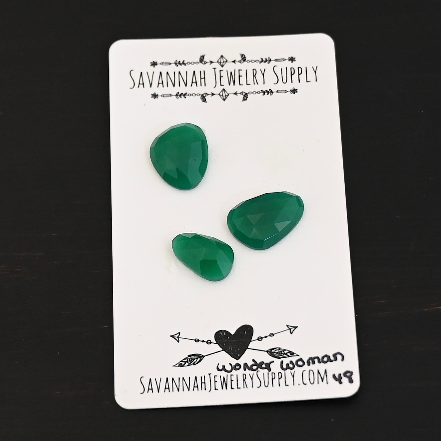 Wonder Woman Rose cut Green Onyx Cabochon Parcel shown on business card