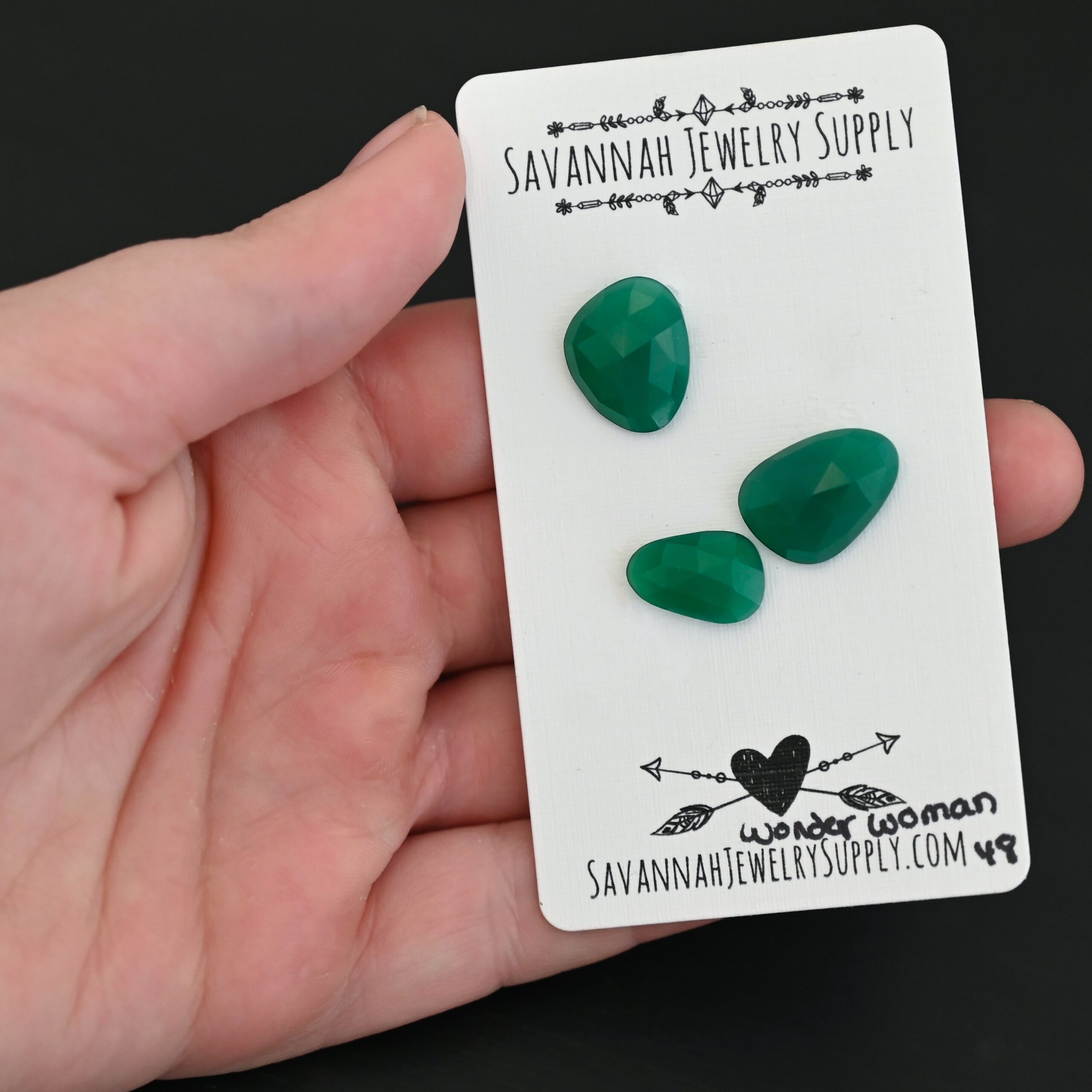 Wonder Woman Rose cut Green Onyx Cabochon Parcel shown in hand