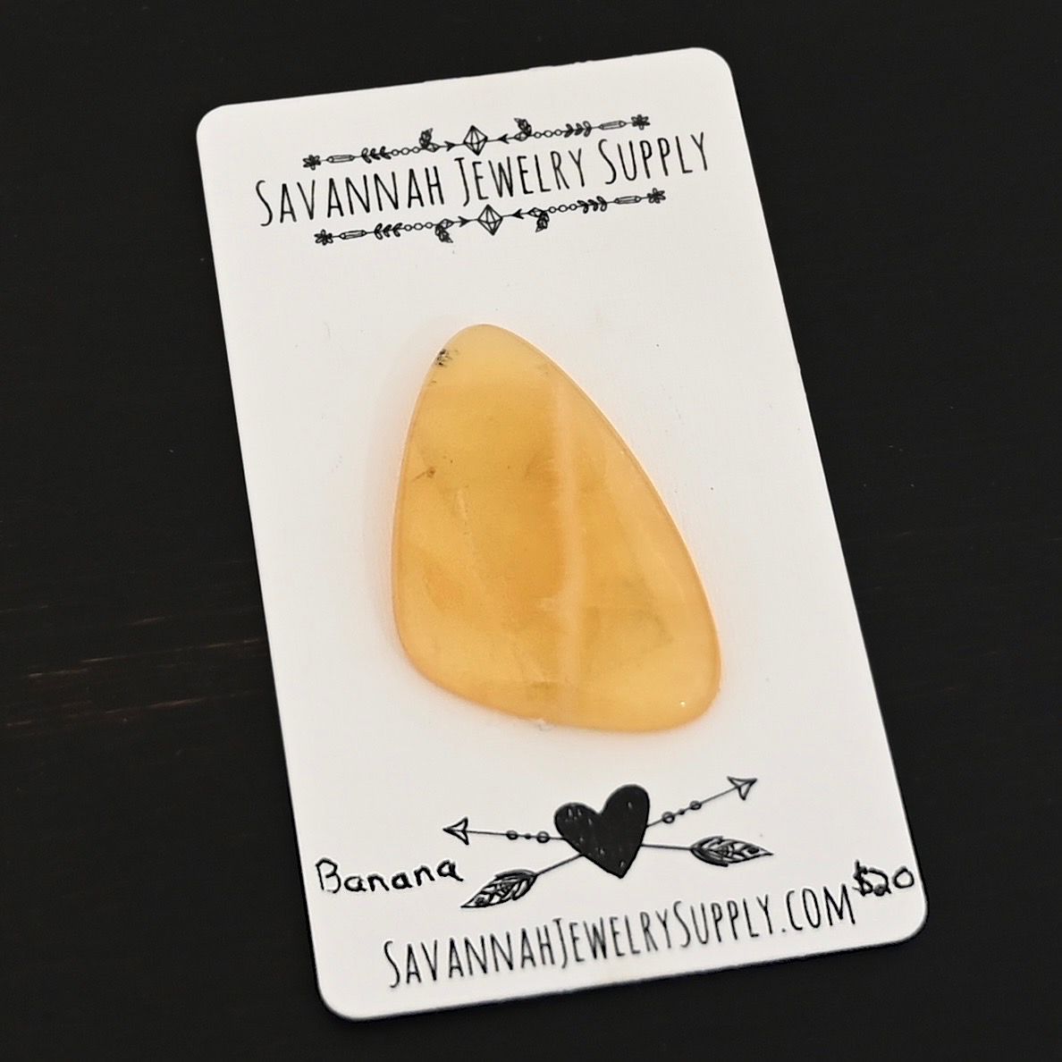 Banana Calcetite Cabochon shown on business card