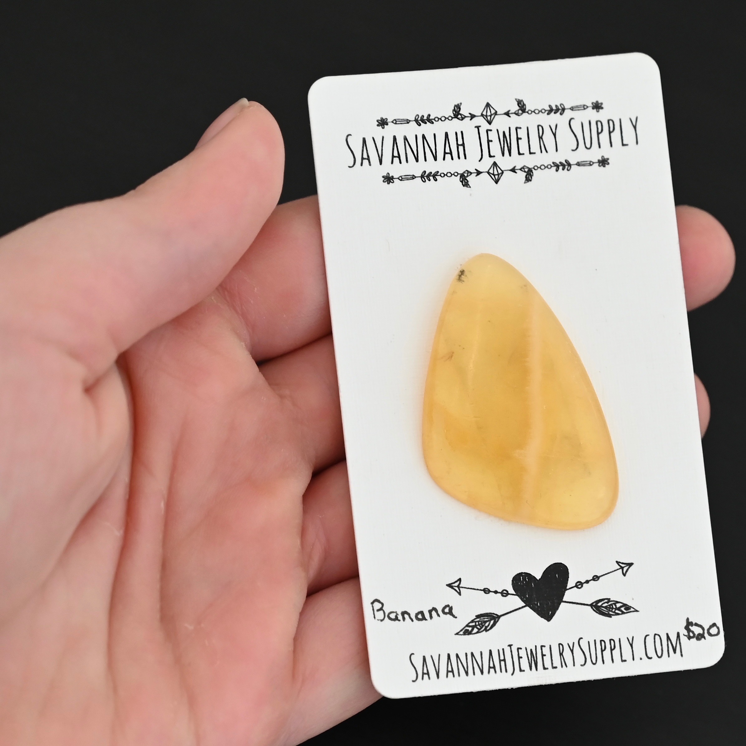 Banana Calcetite Cabochon shown in hand