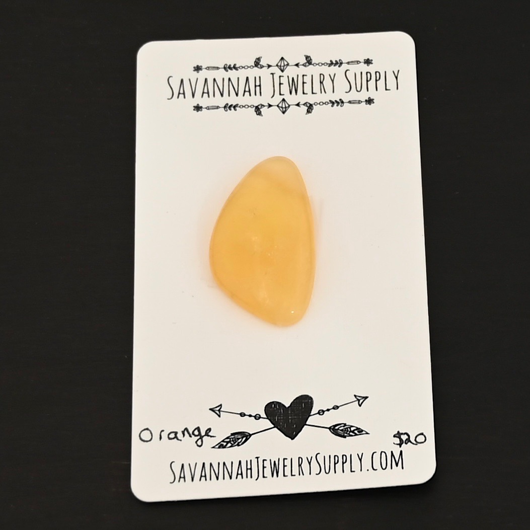 Orange Calcetite Cabochon shown on business card