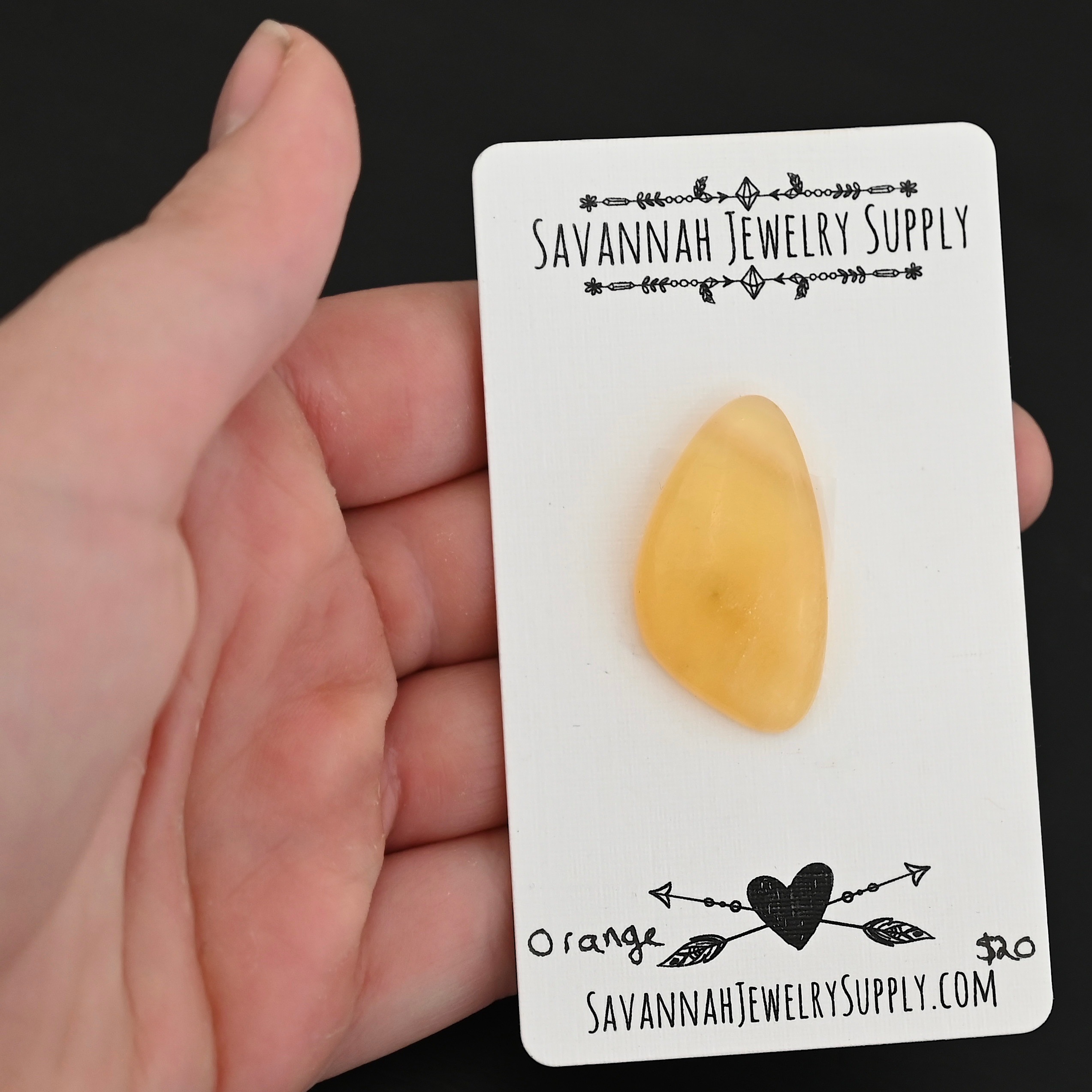 Orange Calcetite Cabochon shown in hand