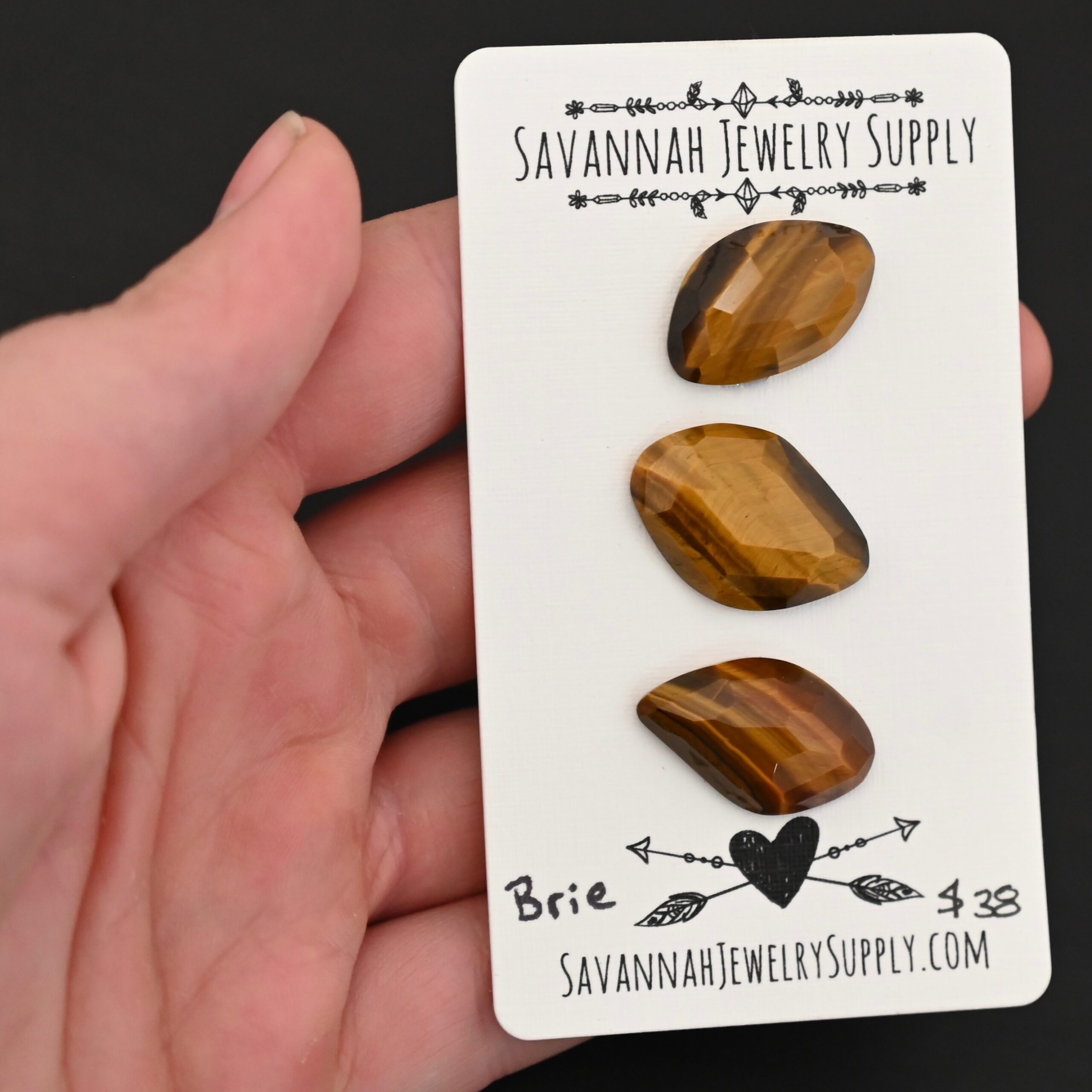 Brie Rosecut Tiger Eye Cabochon Parcel shown in hand