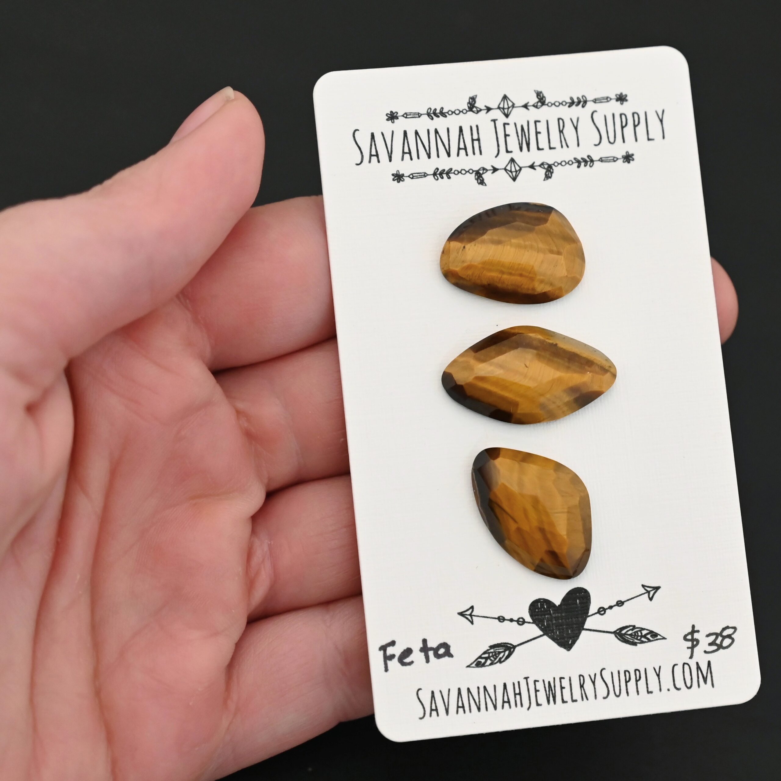 Feta Rosecut Tiger Eye Cabochon Parcel Feta Rosecut Tiger Eye Cabochon Parcel shown in hand