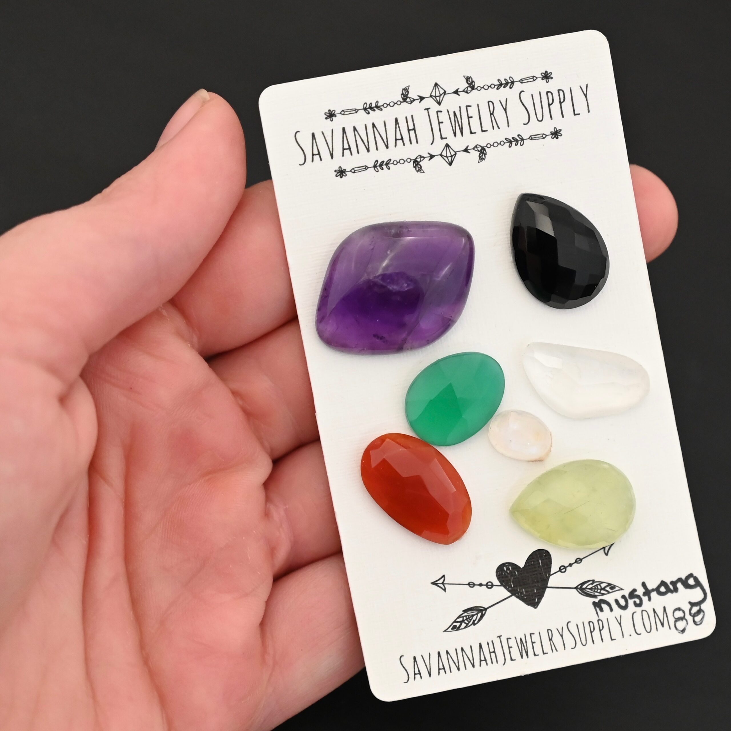 Mustang Rainbow Cabochon Parcel shown in hand