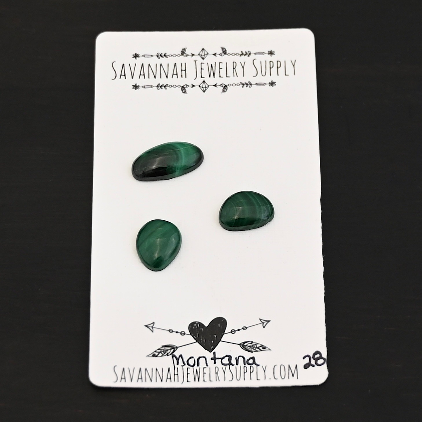 Montana Malachite Cabochon Parcel shown on business card