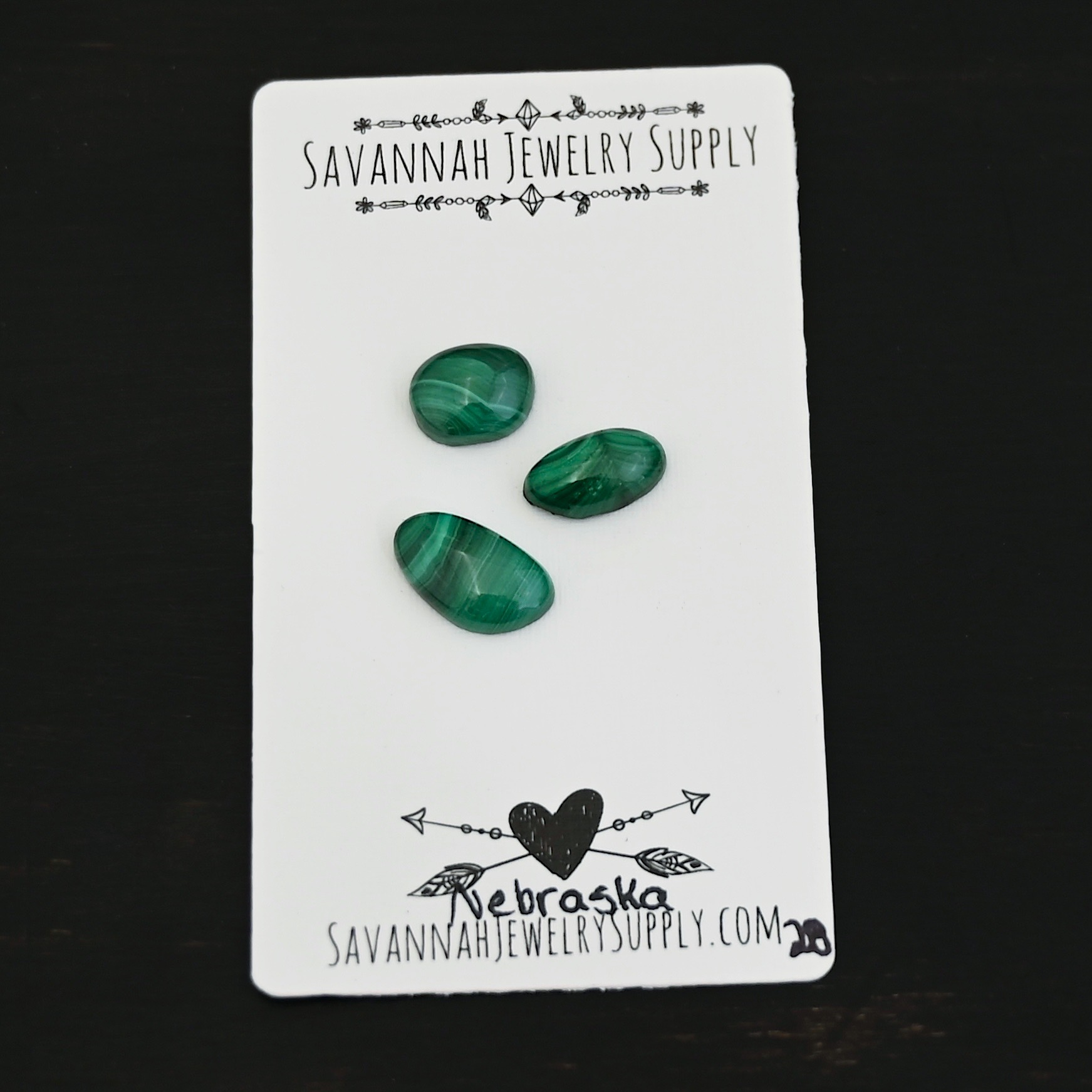Nebraska Malachite Cabochon Parcel shown on business card