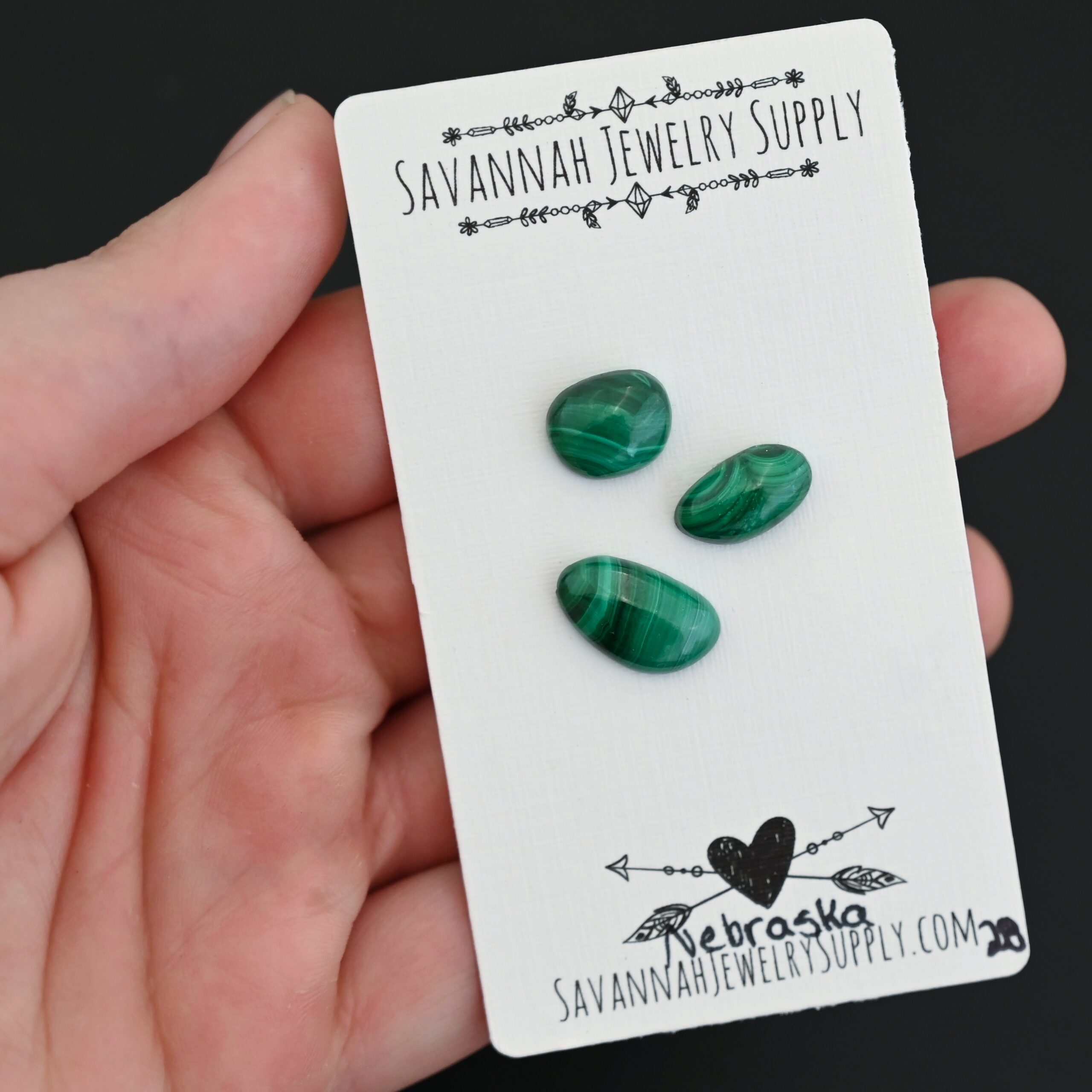Nebraska Malachite Cabochon Parcel shown in hand
