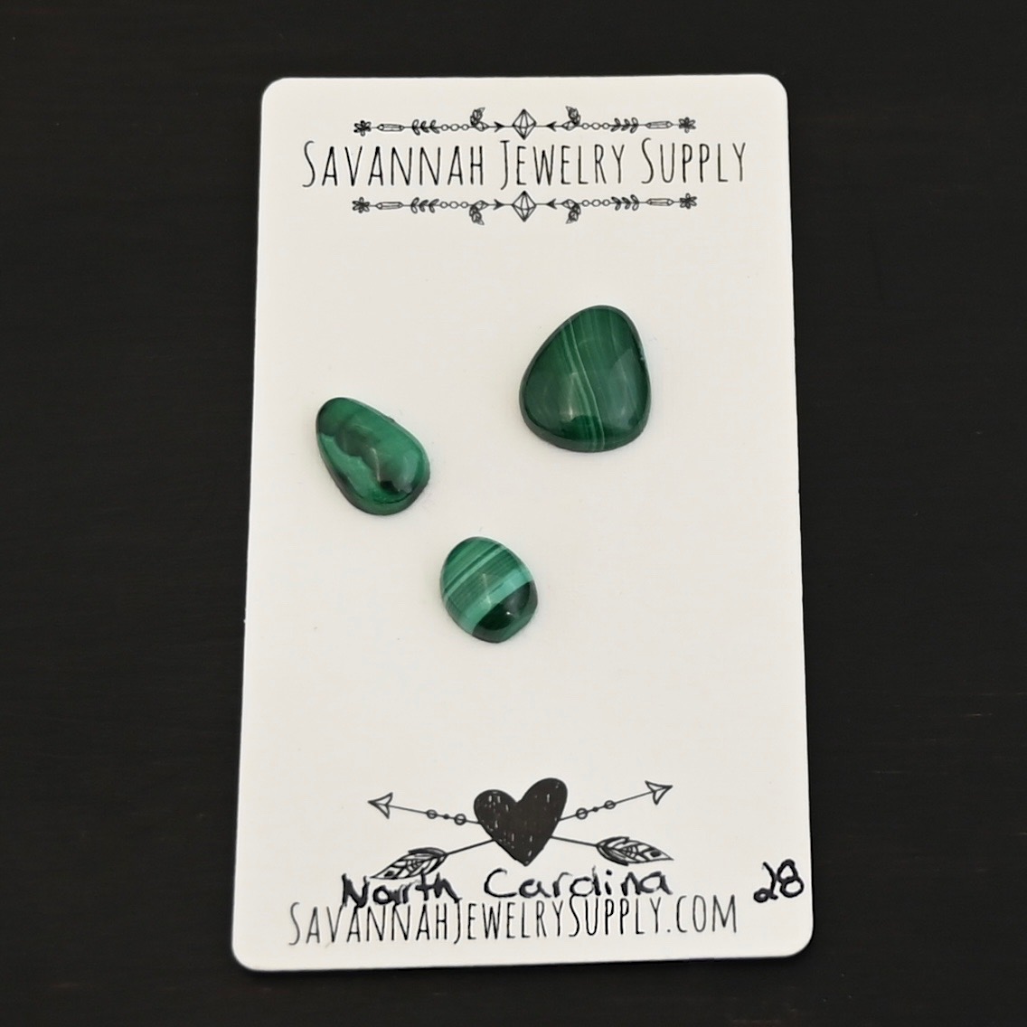 North Carolina Malachite Cabochon Parcel shown on business card