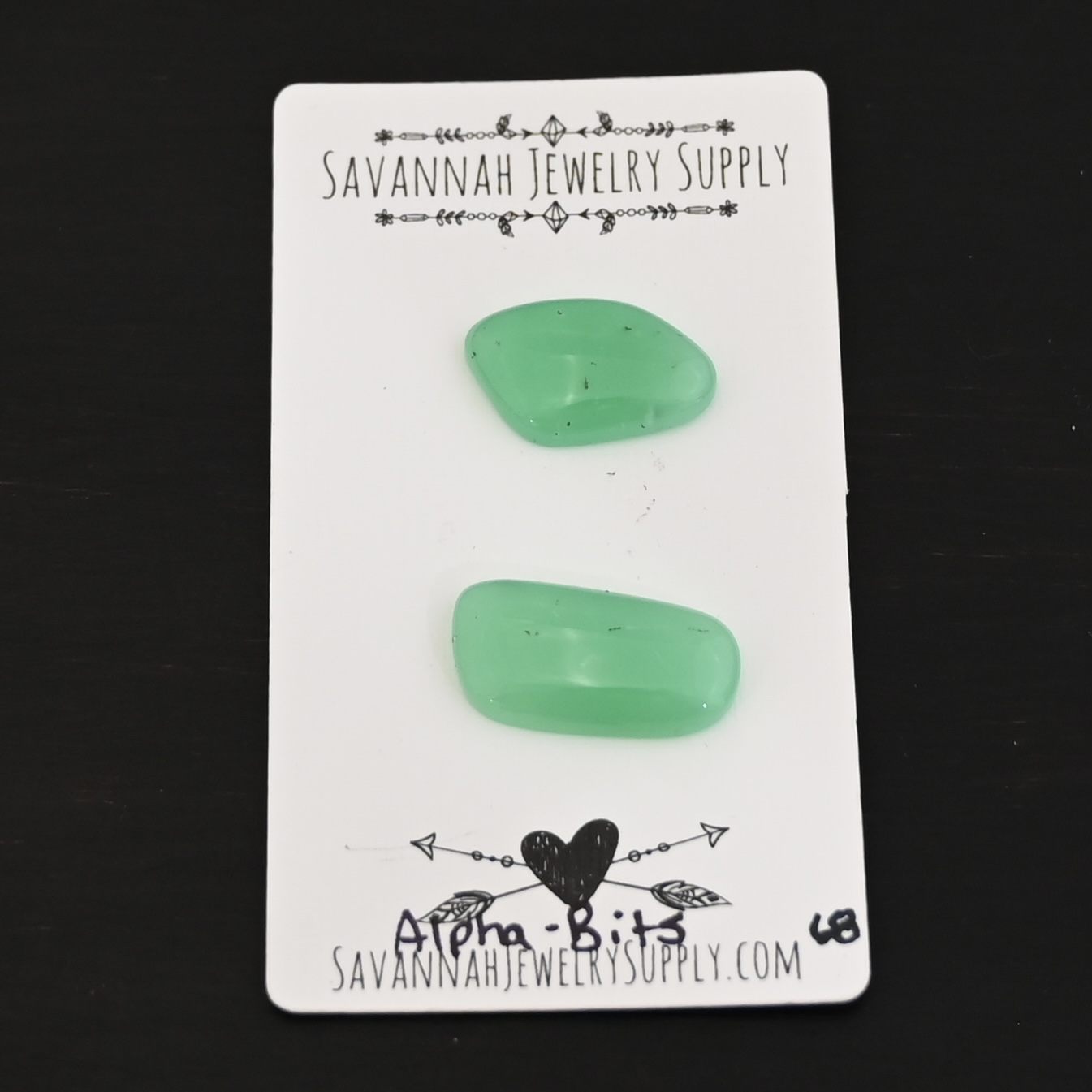 Alpha-Bits Chrysoprase Cabochon Parcel shown on business card