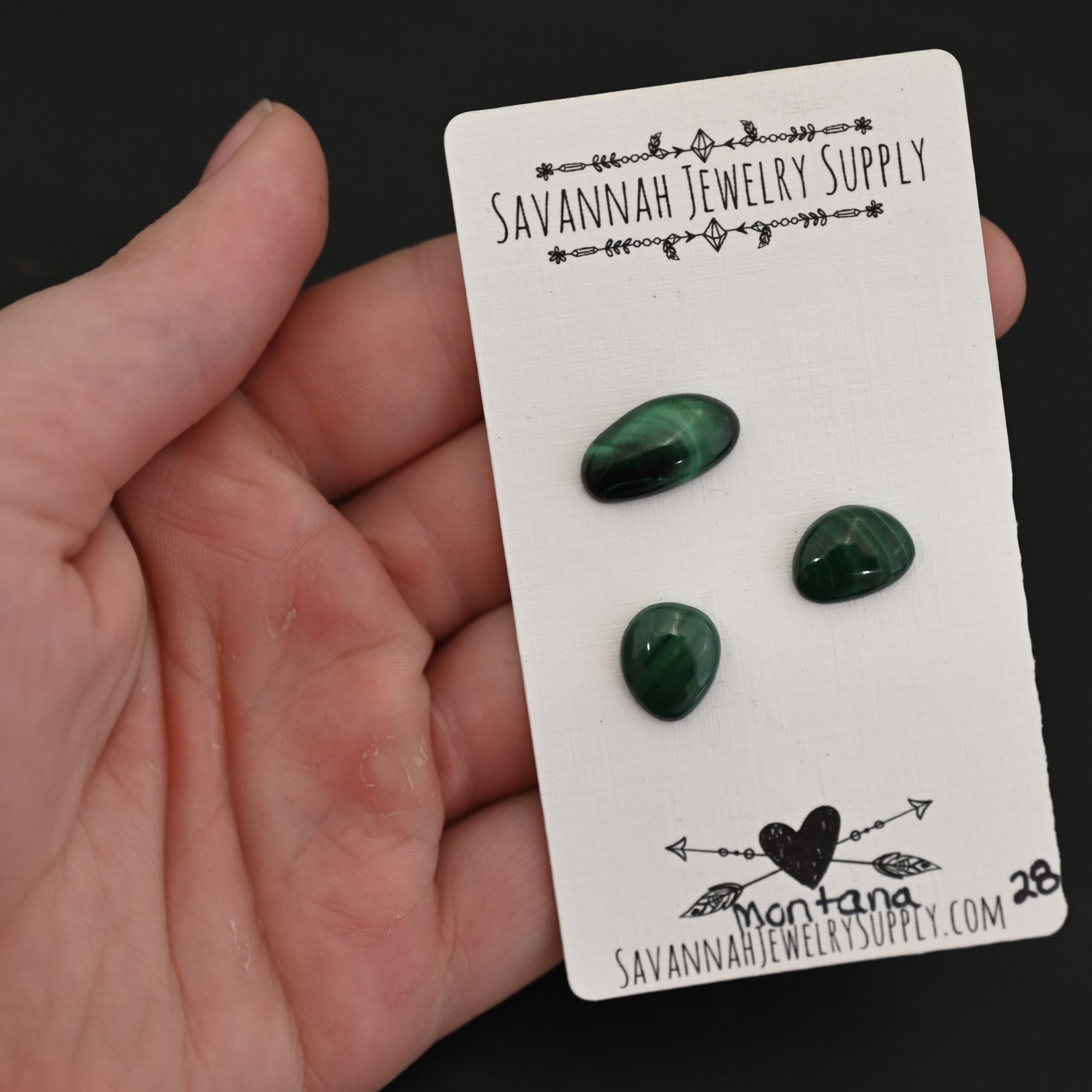 Montana Malachite Cabochon Parcel shown in hand