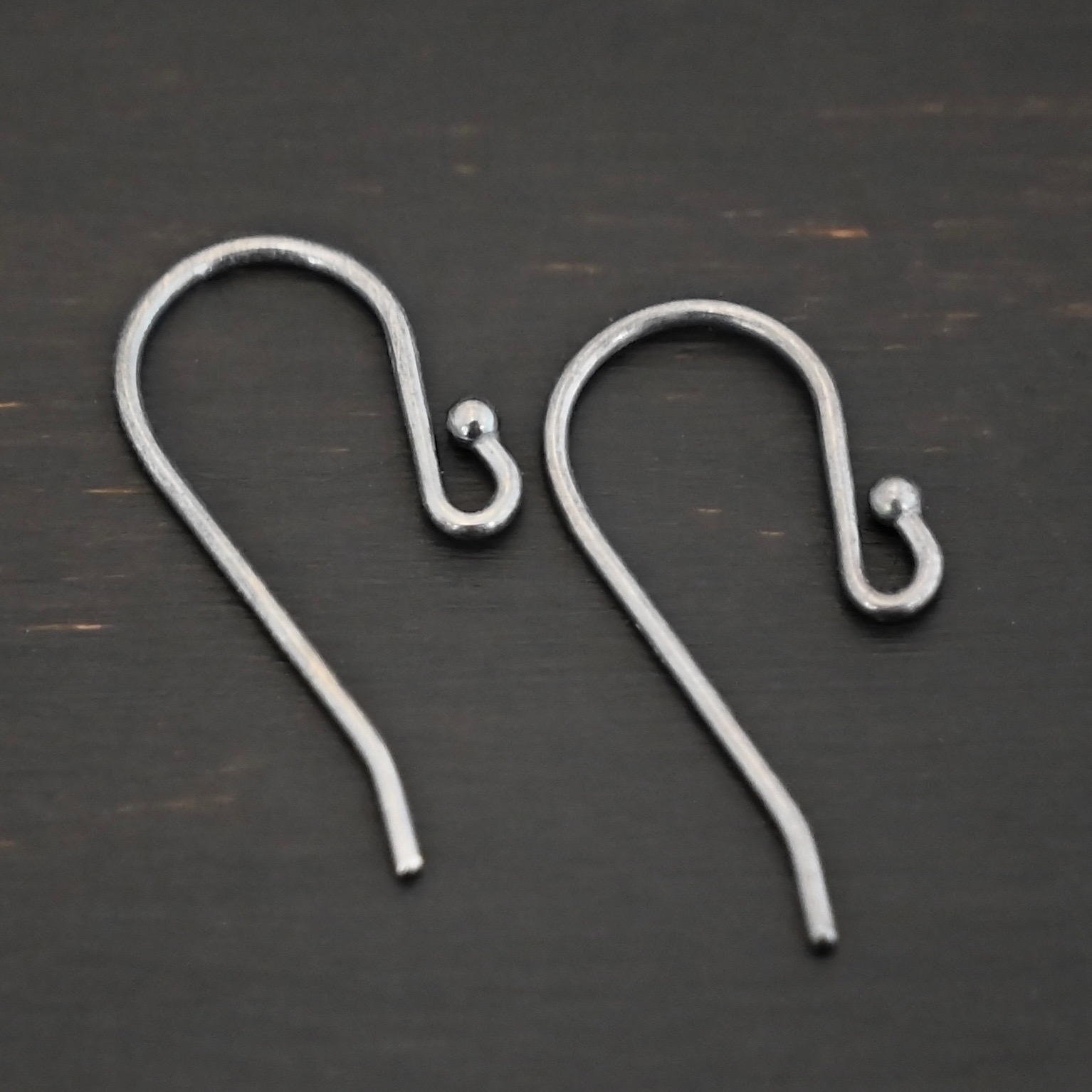 sterling silver Winnie Ear Wires - oxidized shown on dark background