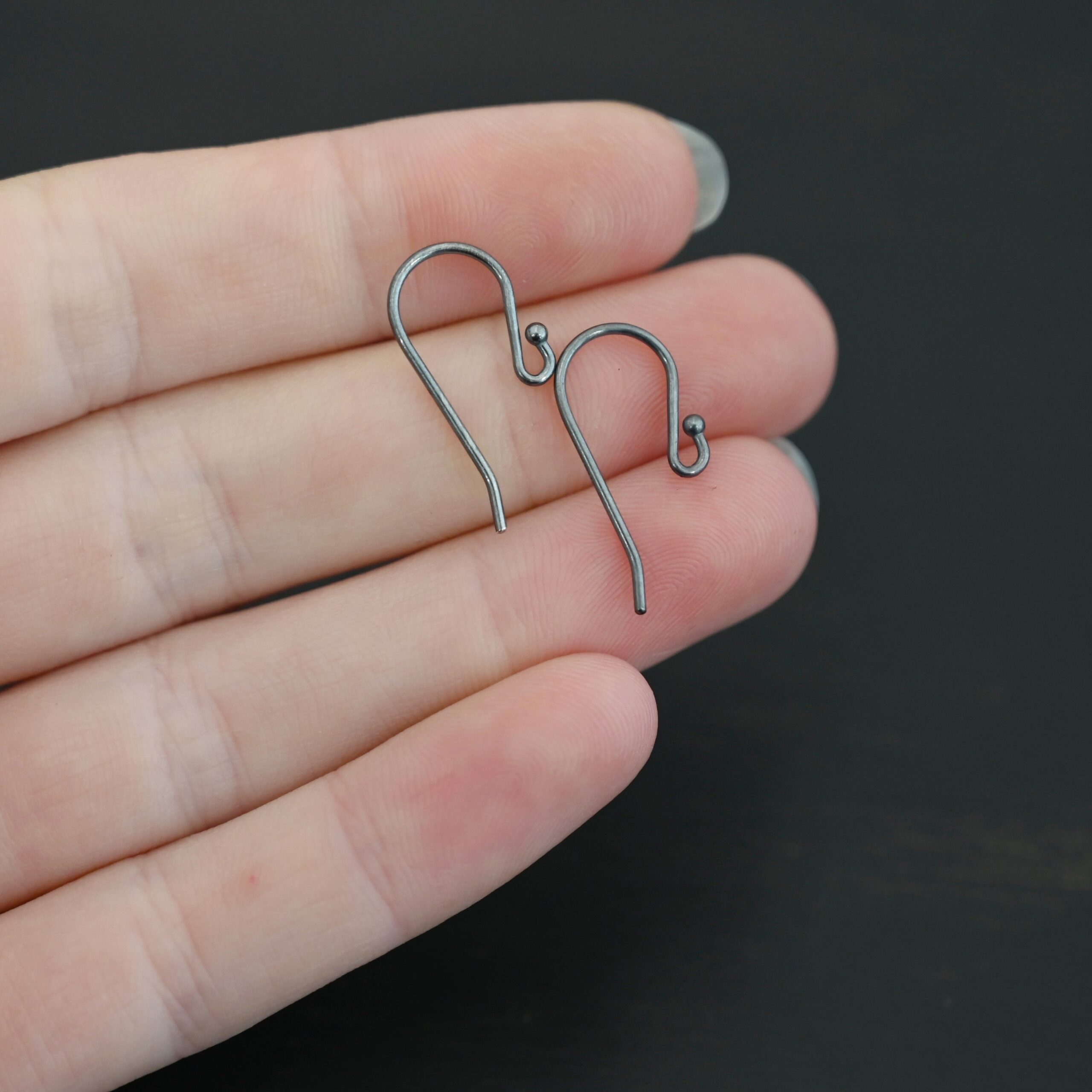 sterling silver Winnie Ear Wires - oxidized shown in hand