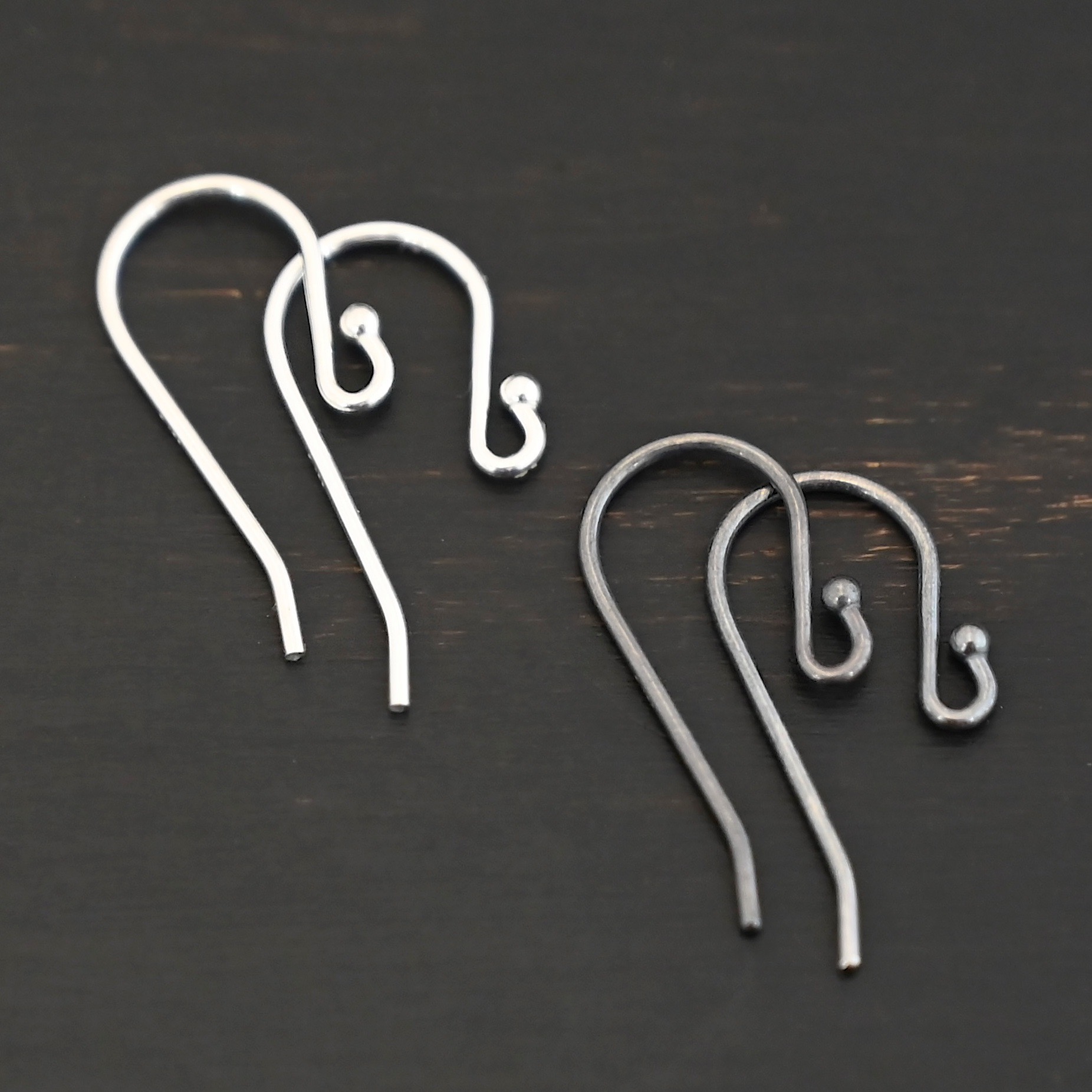 sterling silver Winnie Ear Wires - oxidized & shiny shown on dark background