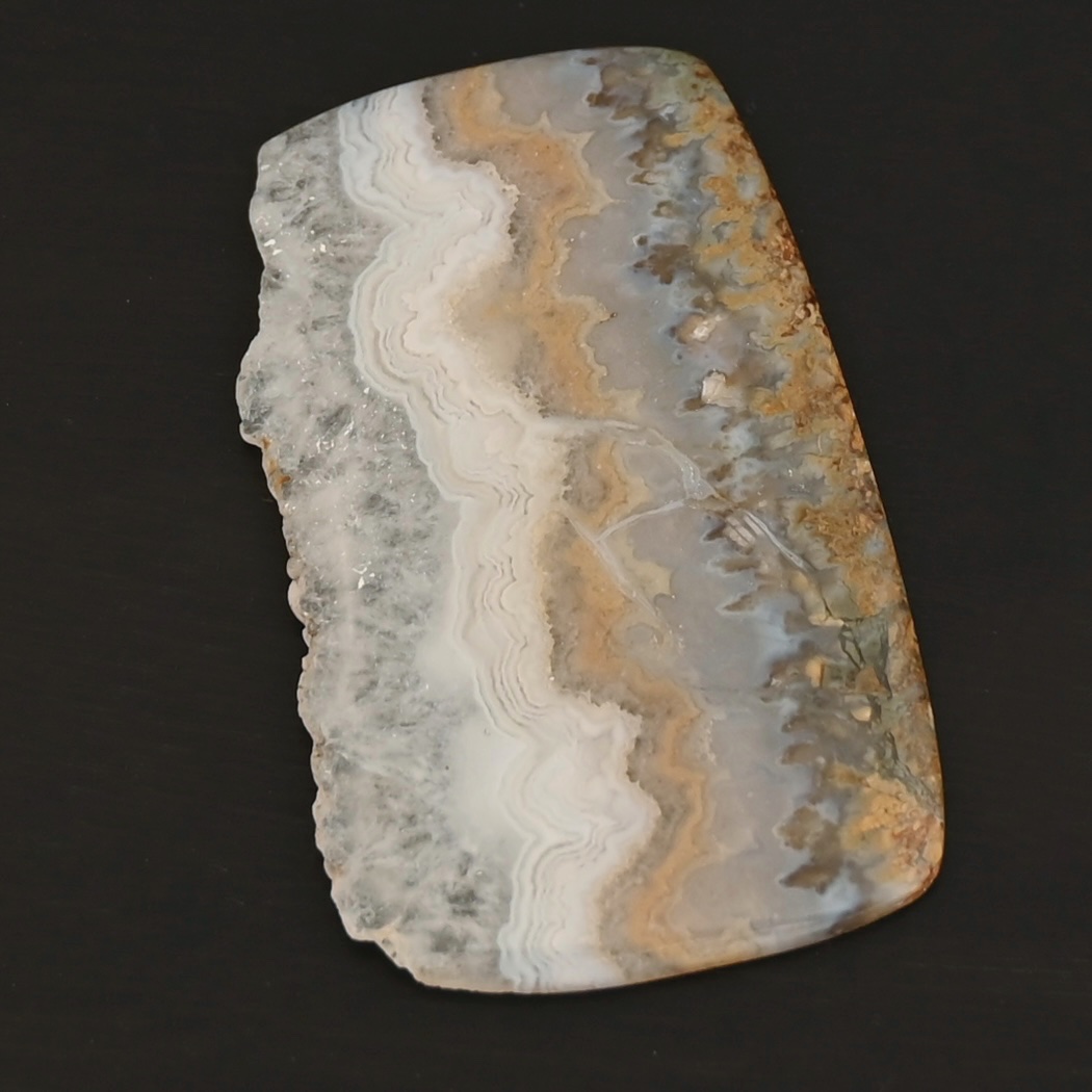 Phoebe Agate Cabochon Phoebe Agate Cabochon shown on dark background