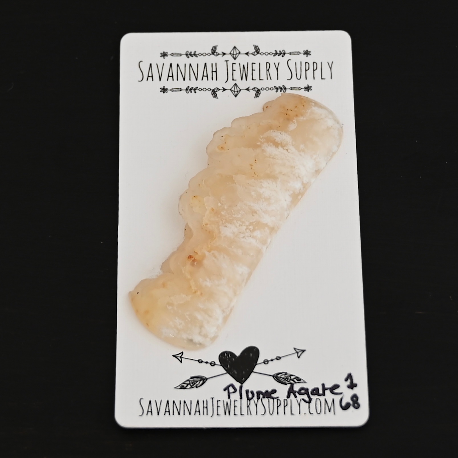 Plume Agate #1 Cabochon shown on business card