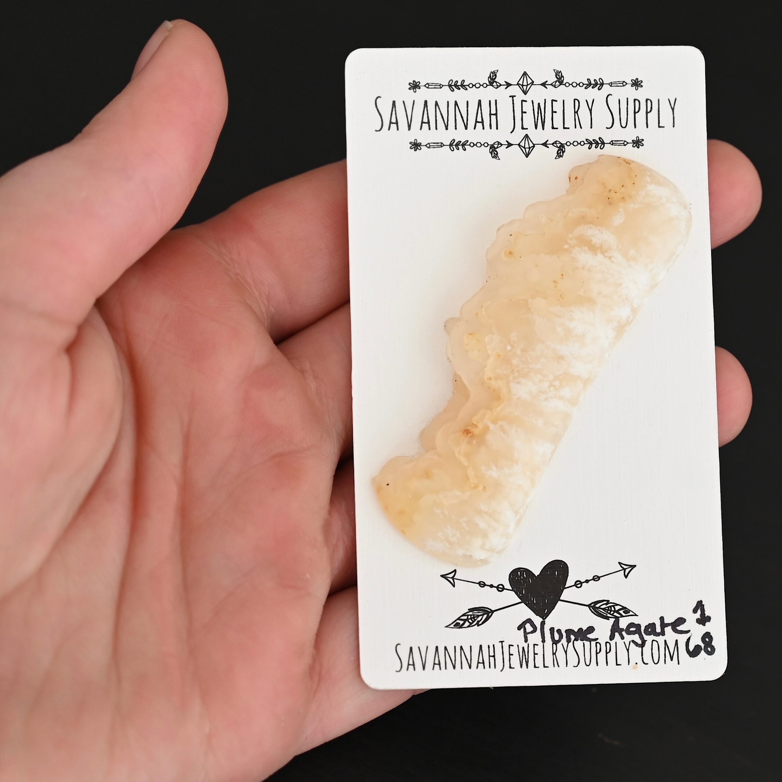 Plume Agate #1 Cabochon shown in hand